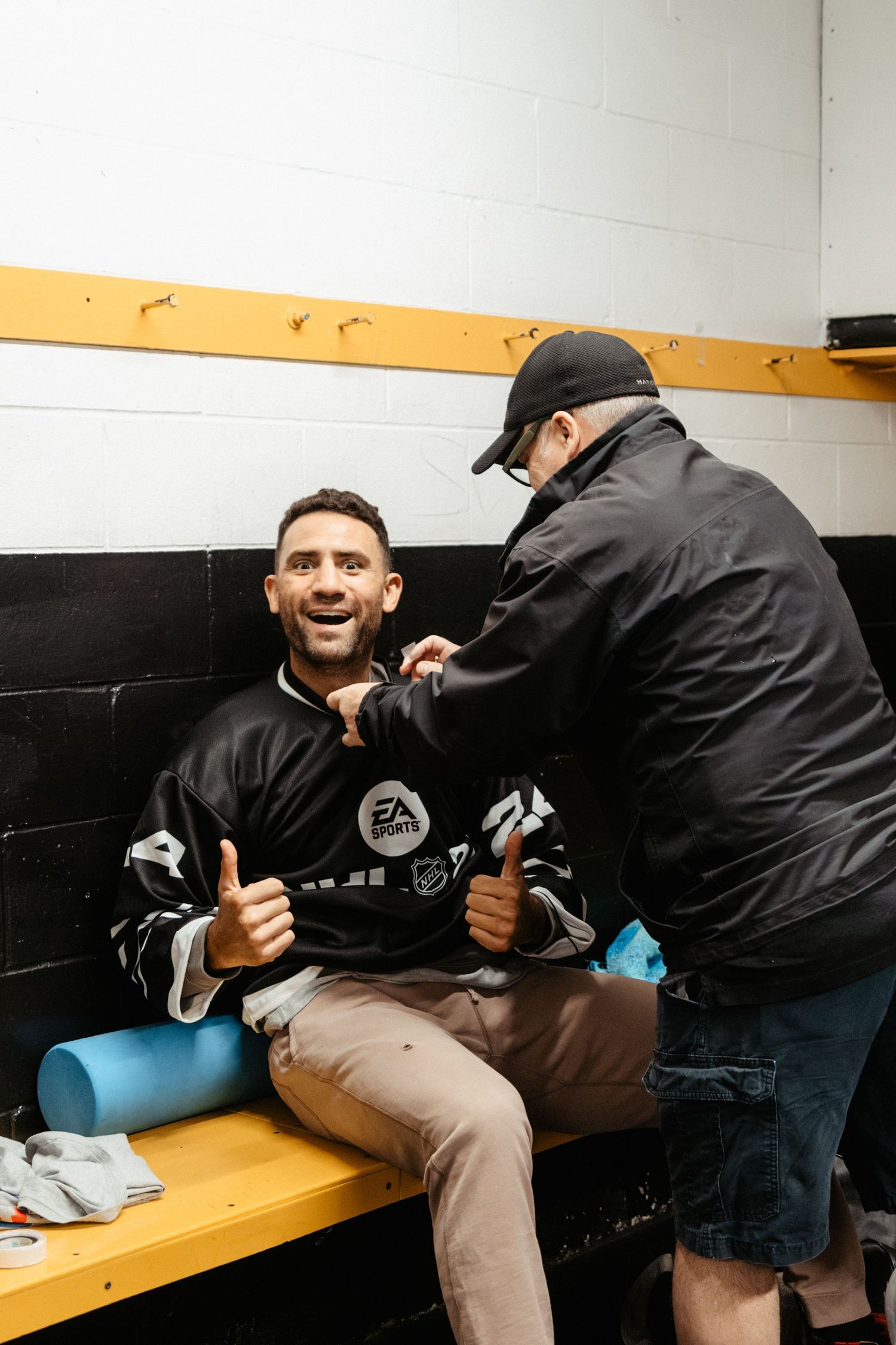 Behind the scenes preparation with athletic equipment in a locker room setting.
