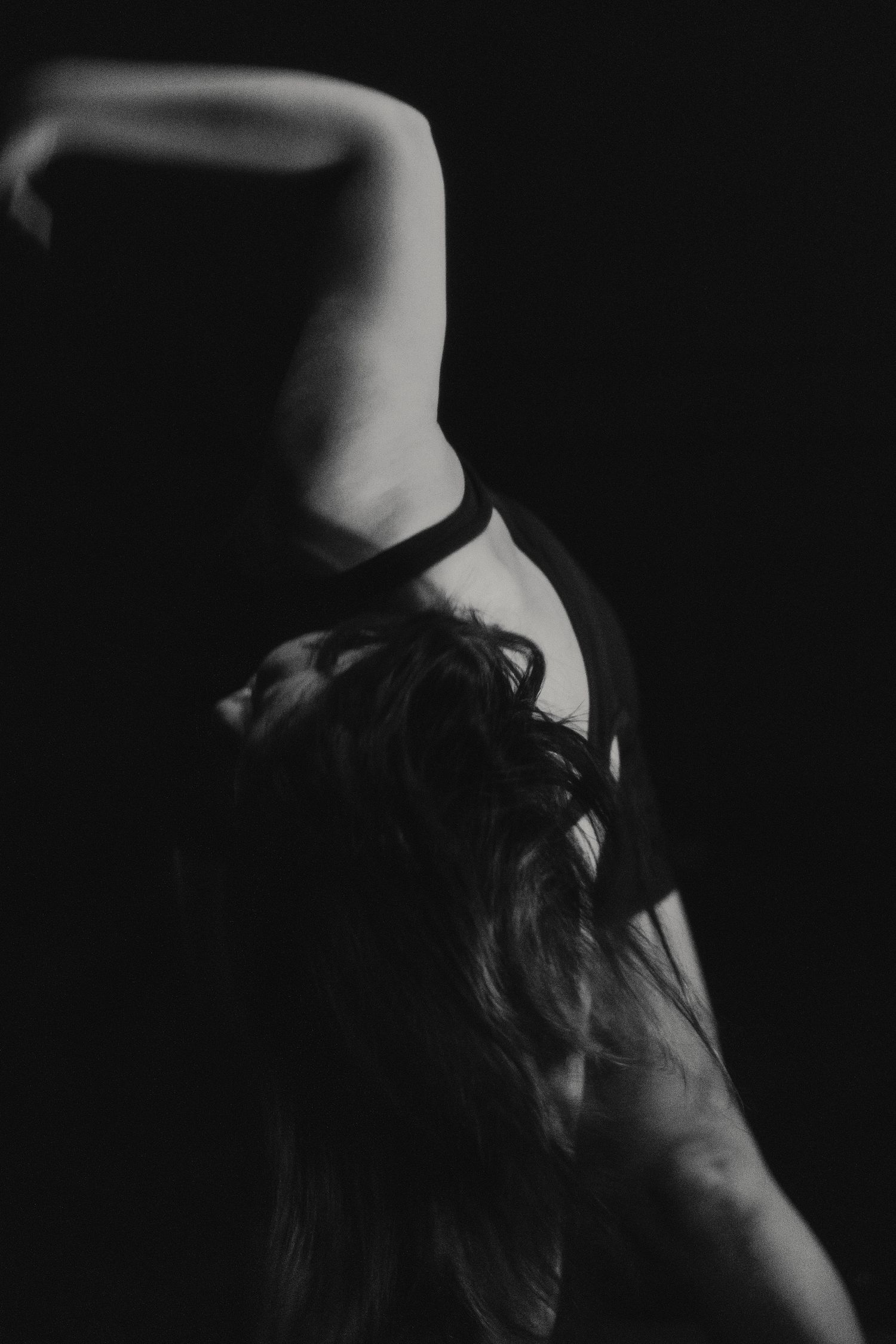 Artistic black and white capture of dancer in graceful backward bend.