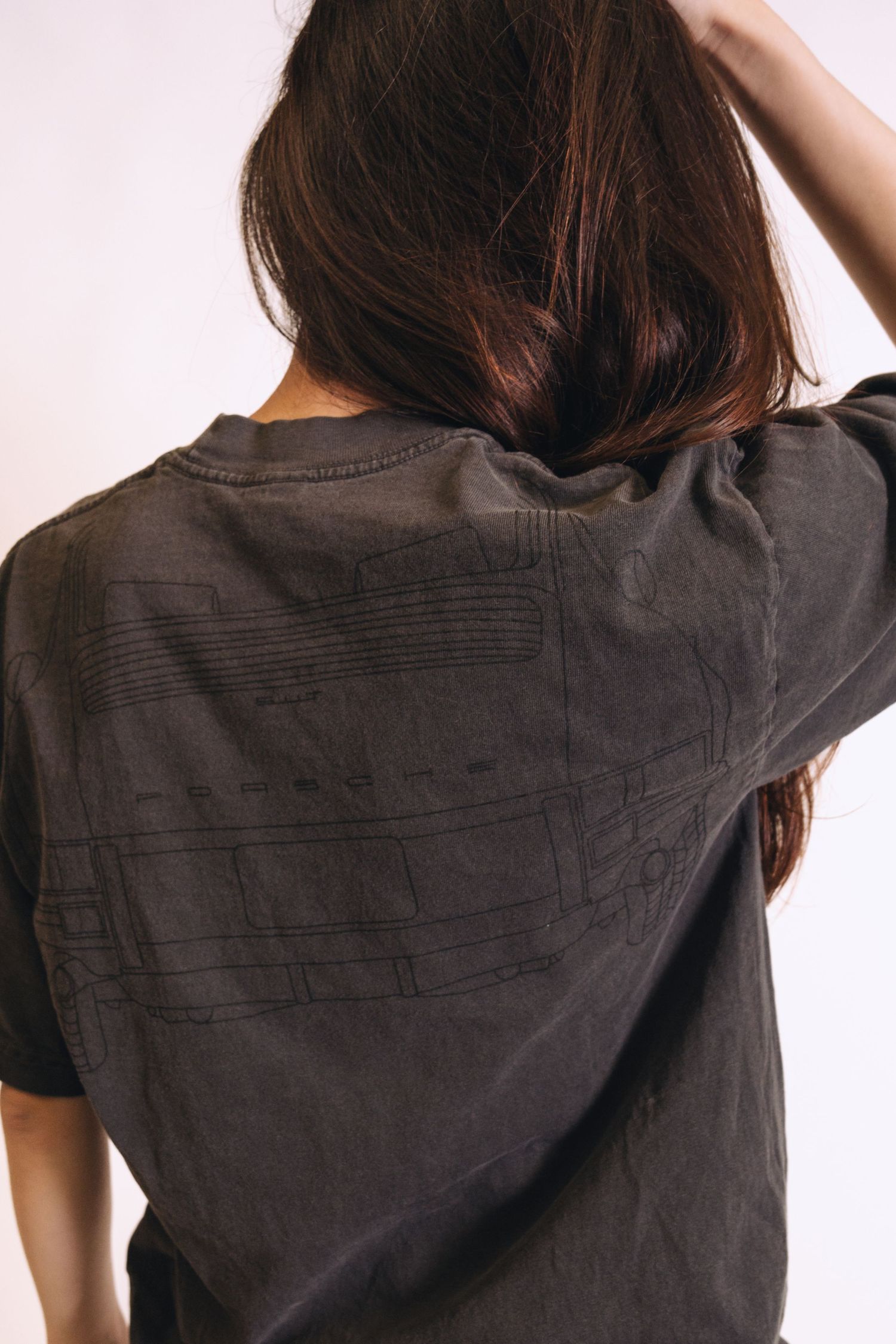 Back view of dark t-shirt showing textured fabric detail.