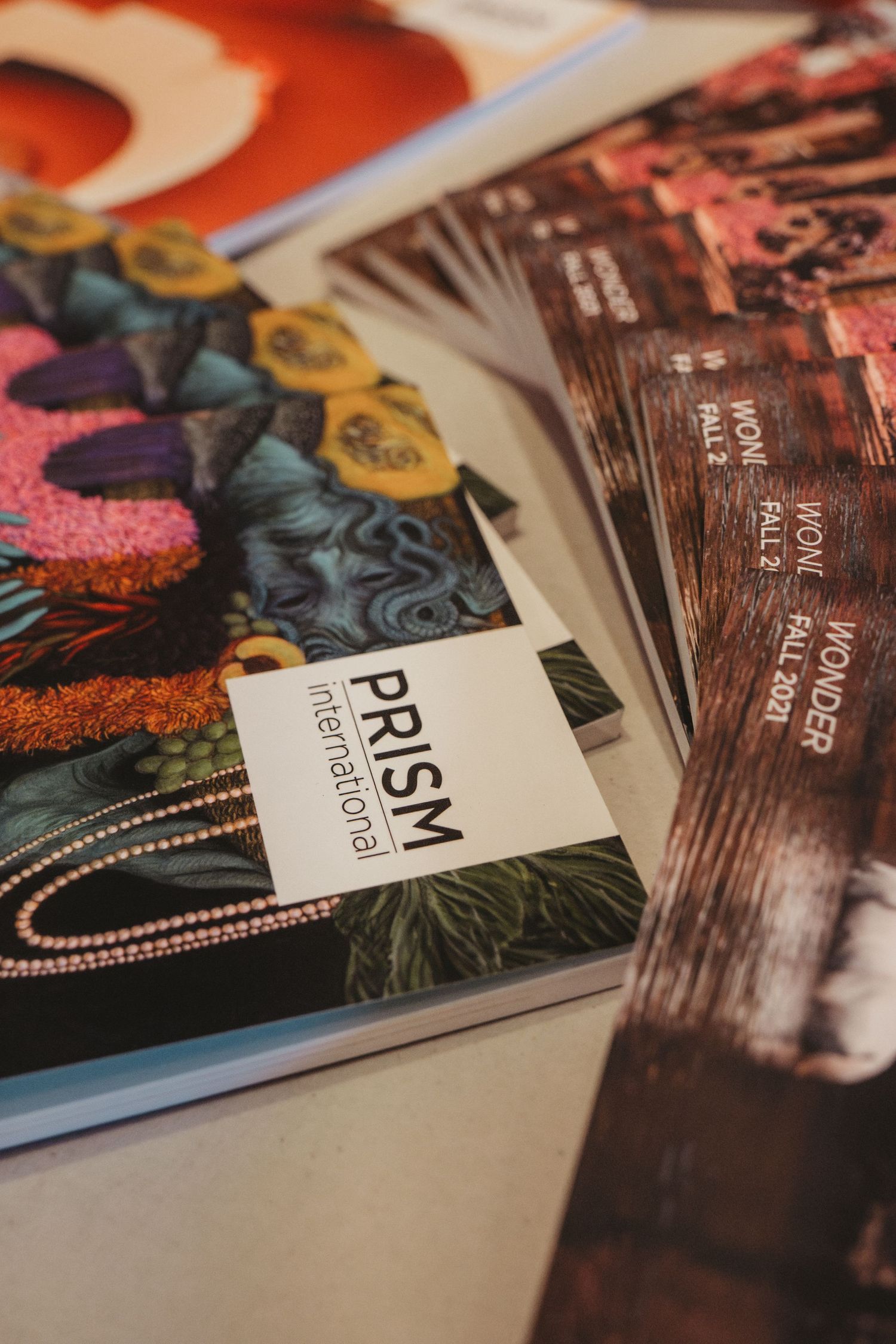 Close-up of PRISM printed magazine with colorful design elements.