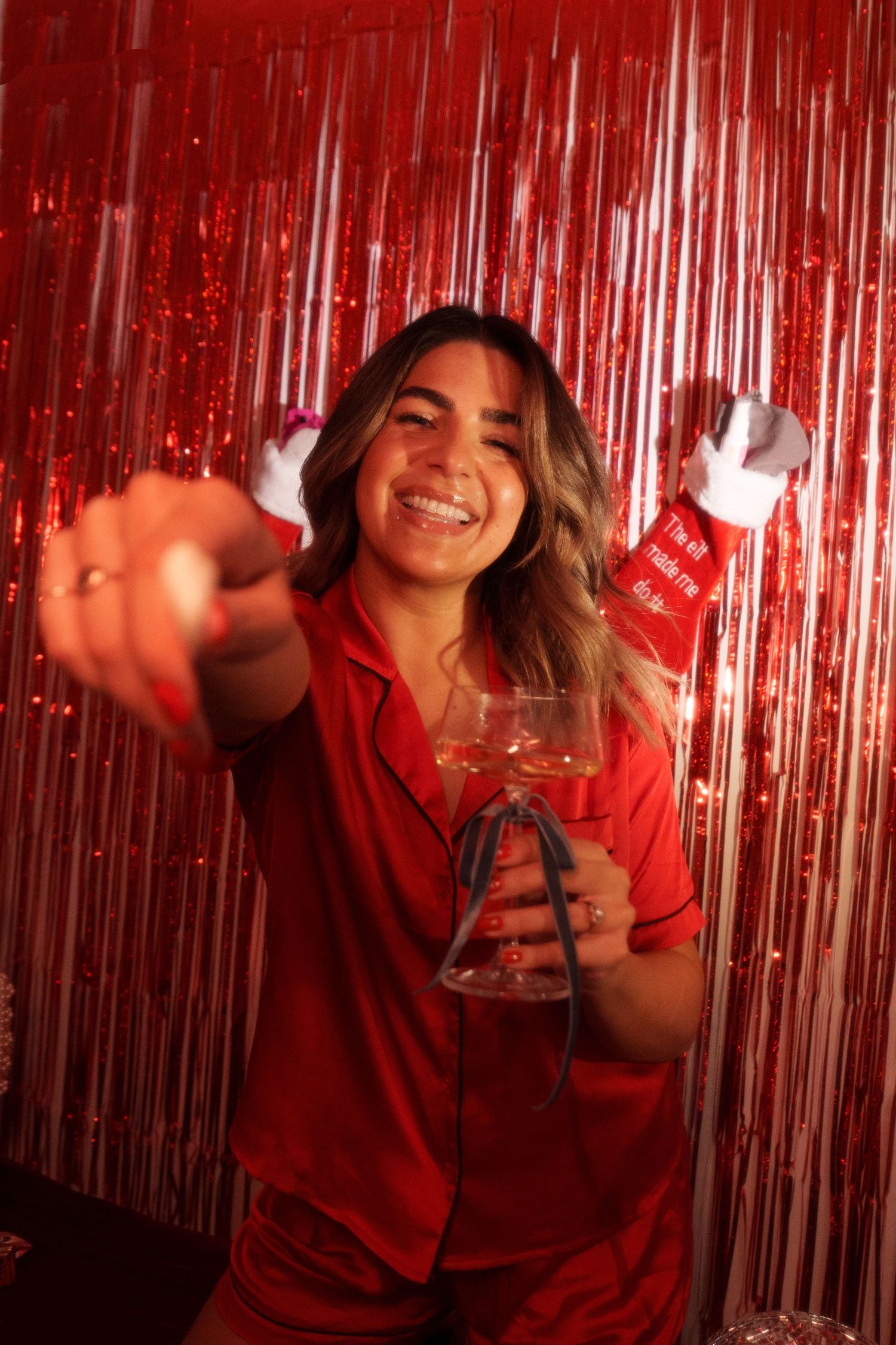 Joyful holiday party scene with red attire and festive decorations.