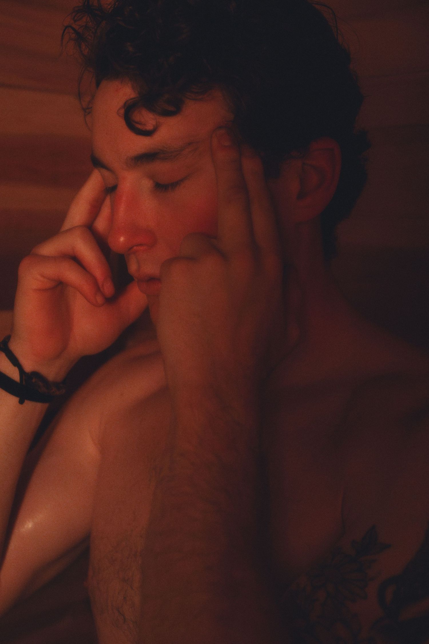 Intimate portrait in warm lighting showing contemplative expression.