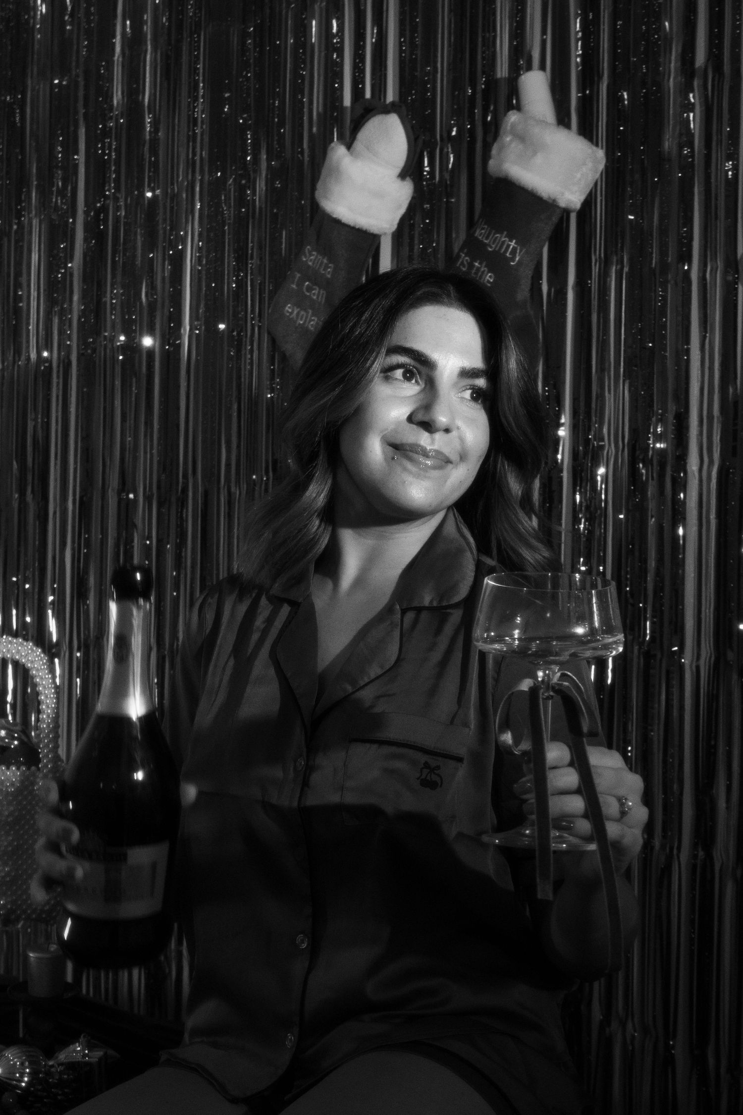 Festive party scene with champagne bottles against a sparkly silver backdrop.