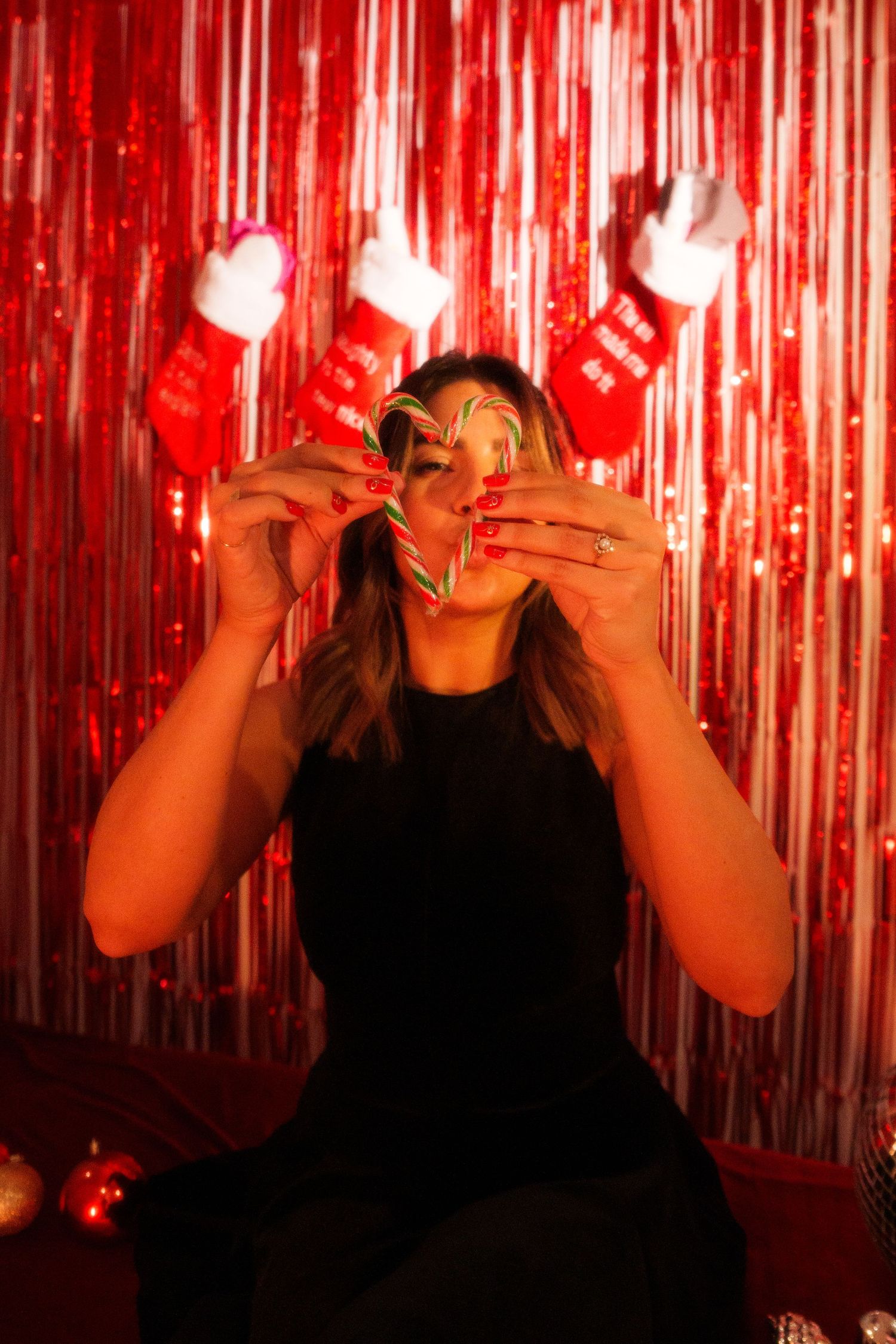 Party setting with festive red backdrop and playful holiday accessories.