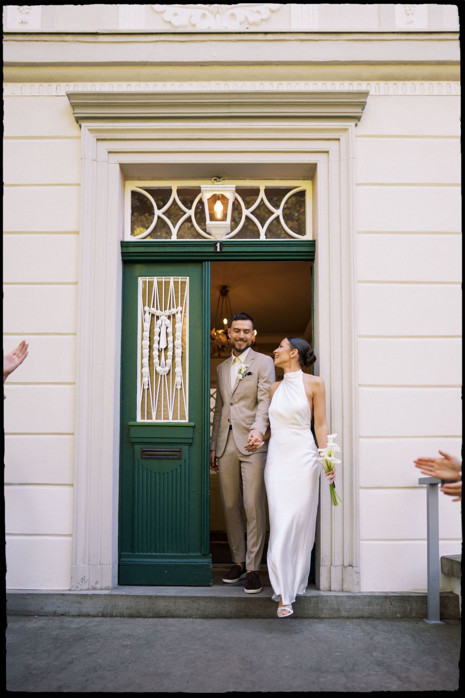A sequence of photos showing a couple emerging from a green doorway in formal wedding attire.