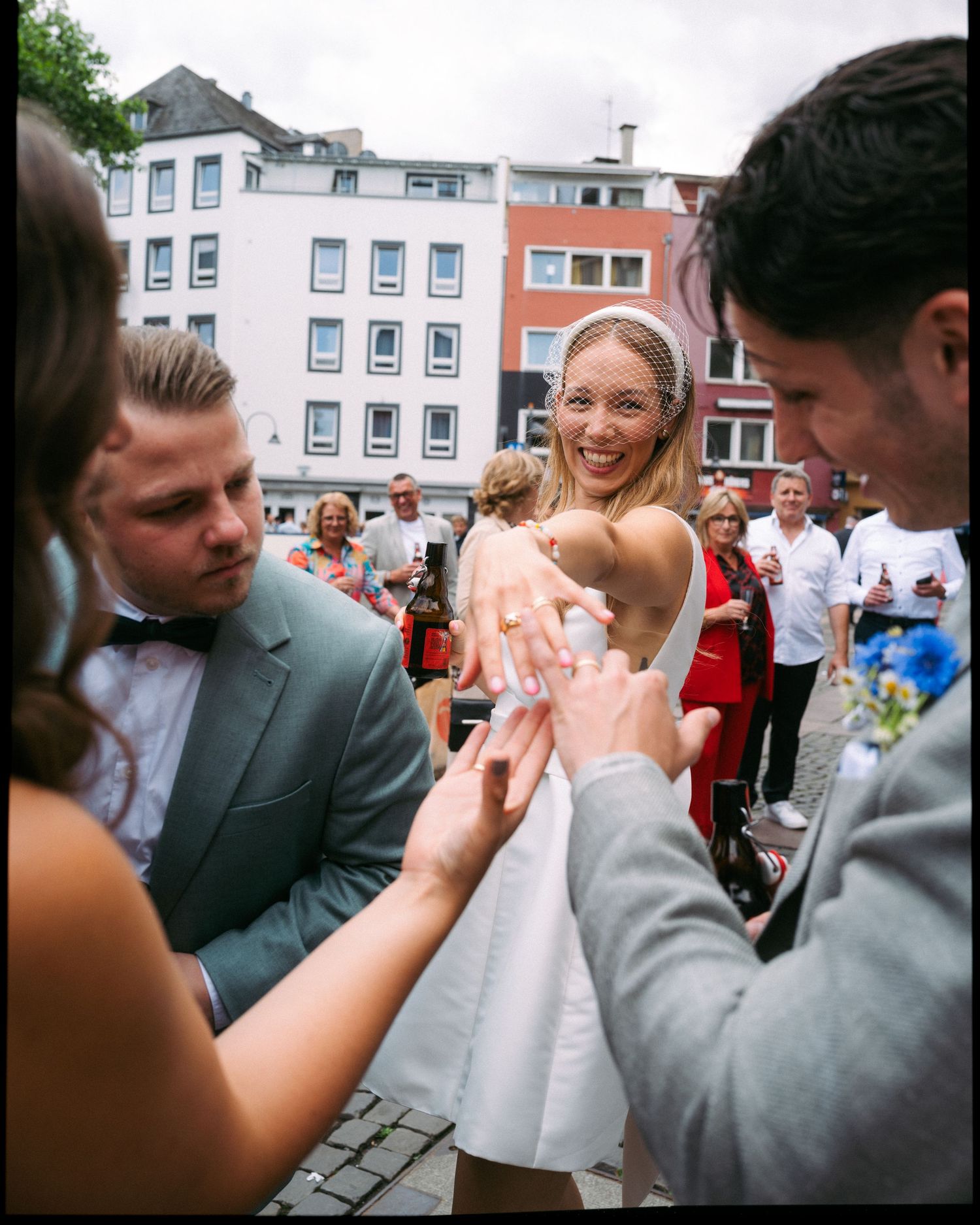 A sequence of playful moments at an outdoor wedding celebration shows guests and newlyweds interacting joyfully.
