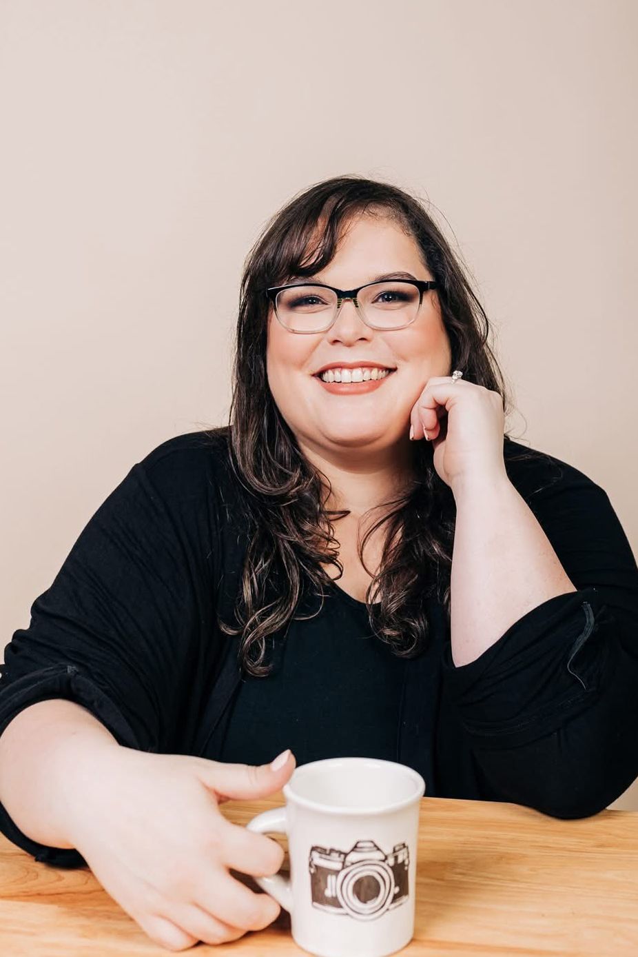 A sequence of photos showing someone in a black sweater leaning on a wooden table with a coffee cup, smiling warmly.