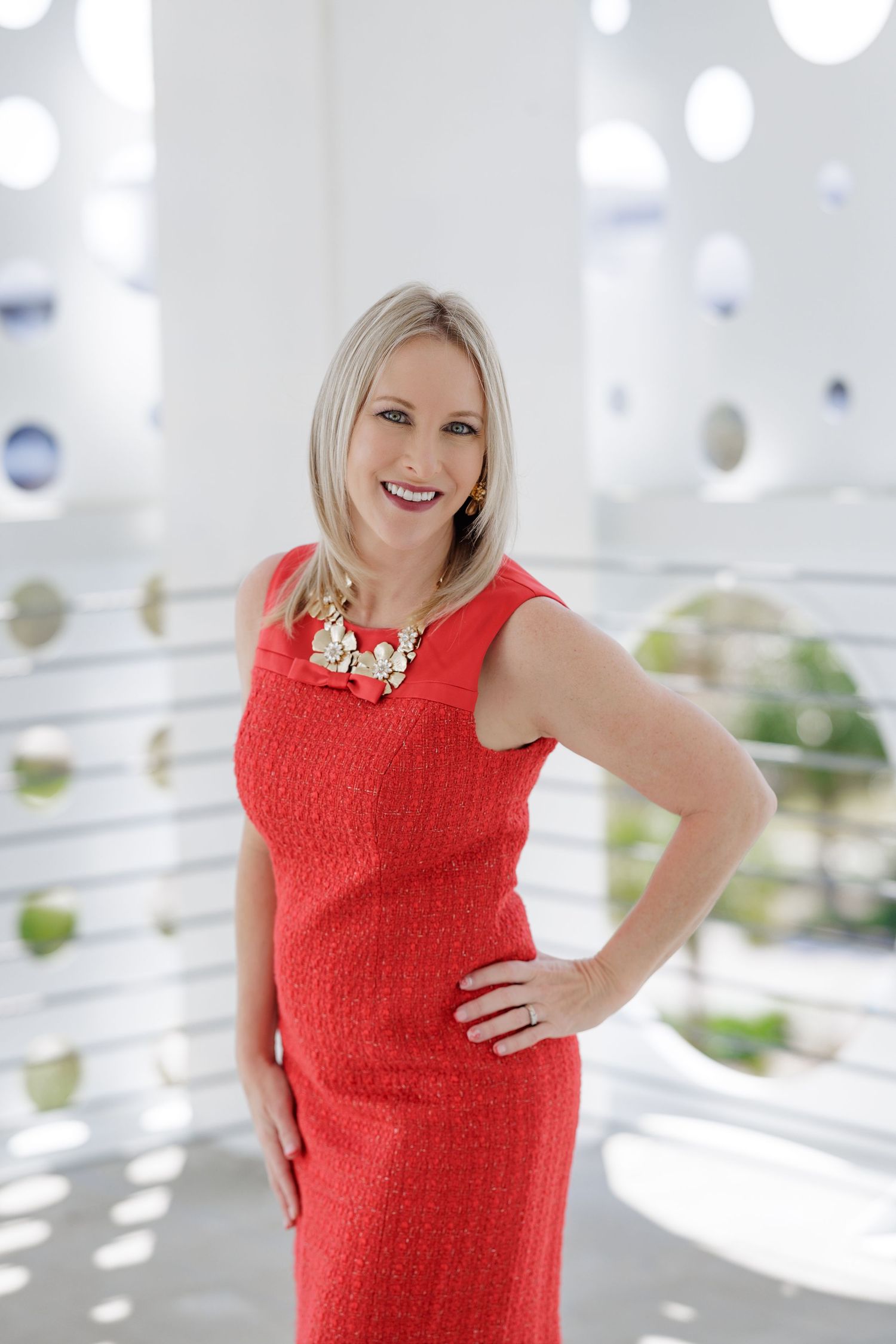Professional portrait session in bright modern space with red dress.