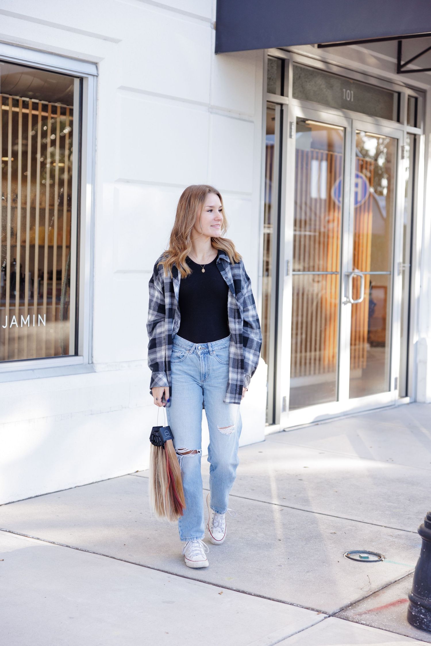 Casual street style photos featuring plaid shirt and distressed jeans outside storefront.