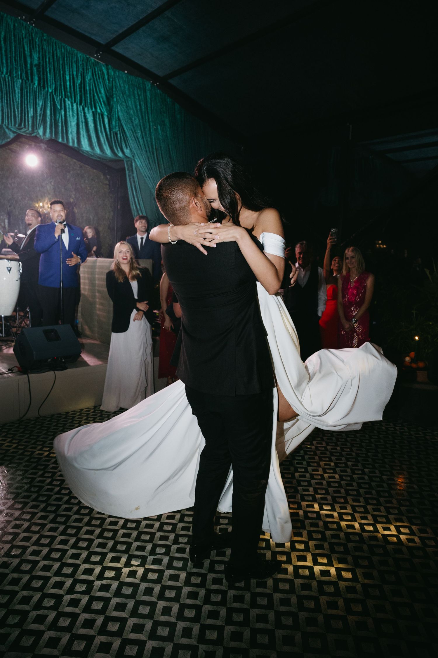 A sequence of wedding dance photos showing a couple performing a dip move on a patterned dance floor.