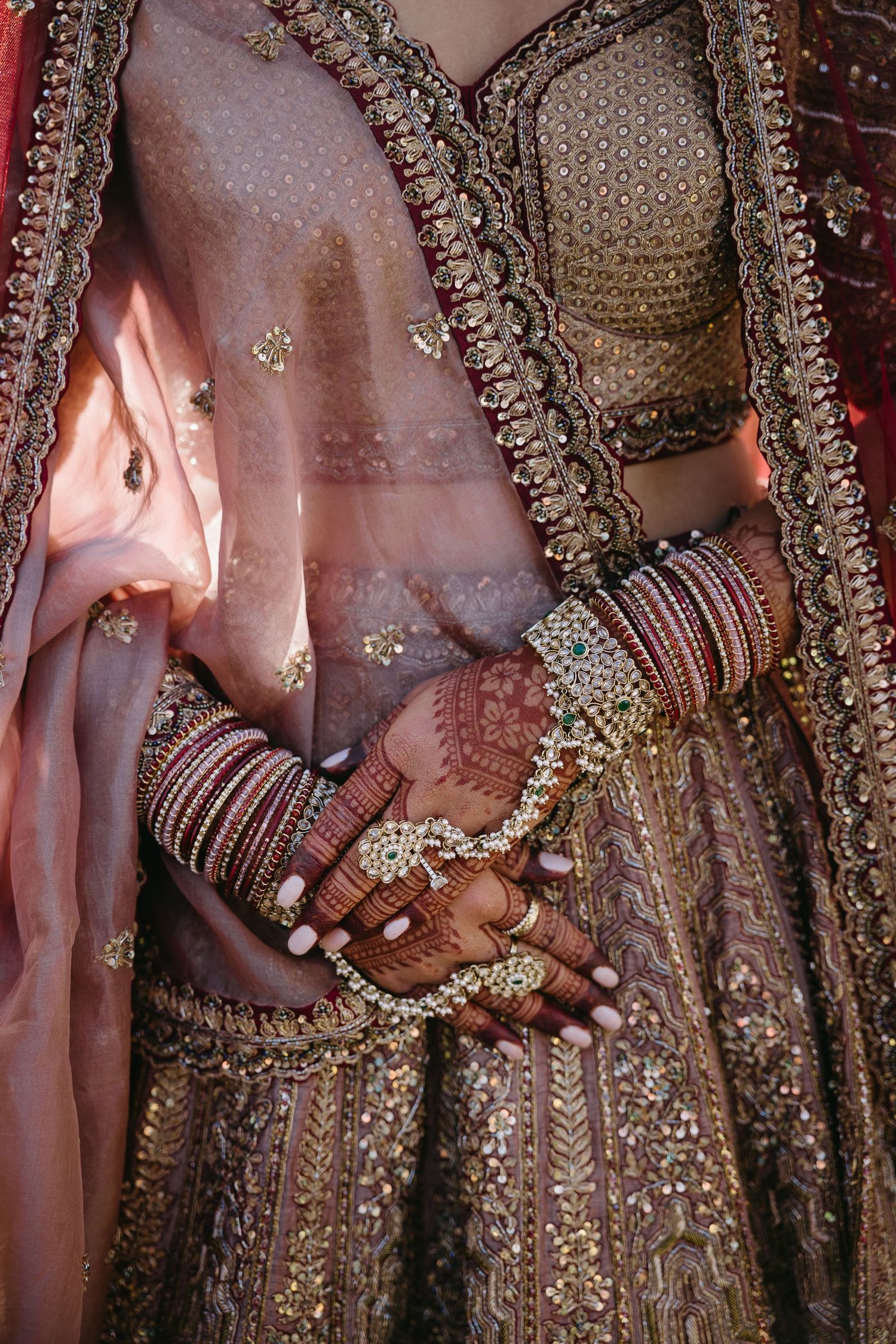 Close-up shots of traditional Indian bridal jewelry and hands adorned with bangles and mehndi designs during a wedding ceremony.