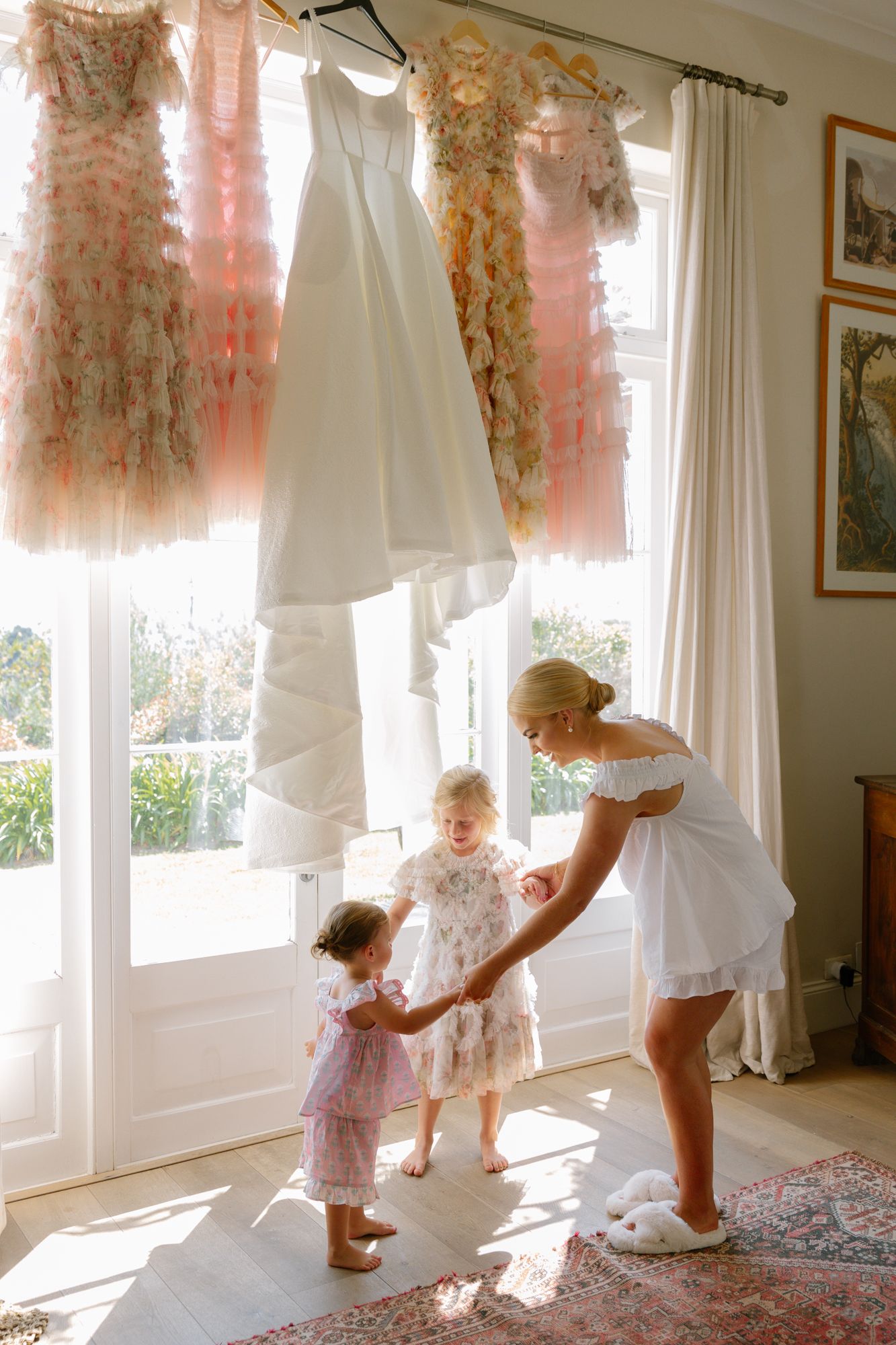 A sequence of photos showing a toddler dancing and twirling in front of sunlit windows with sheer curtains.
