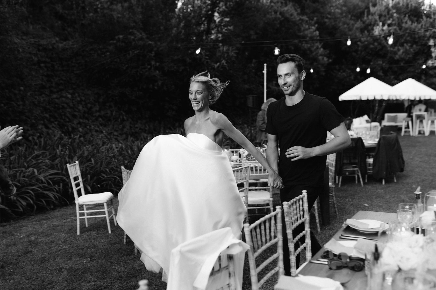 A sequence of black and white wedding reception photos showing guests dancing and celebrating at an outdoor venue.
