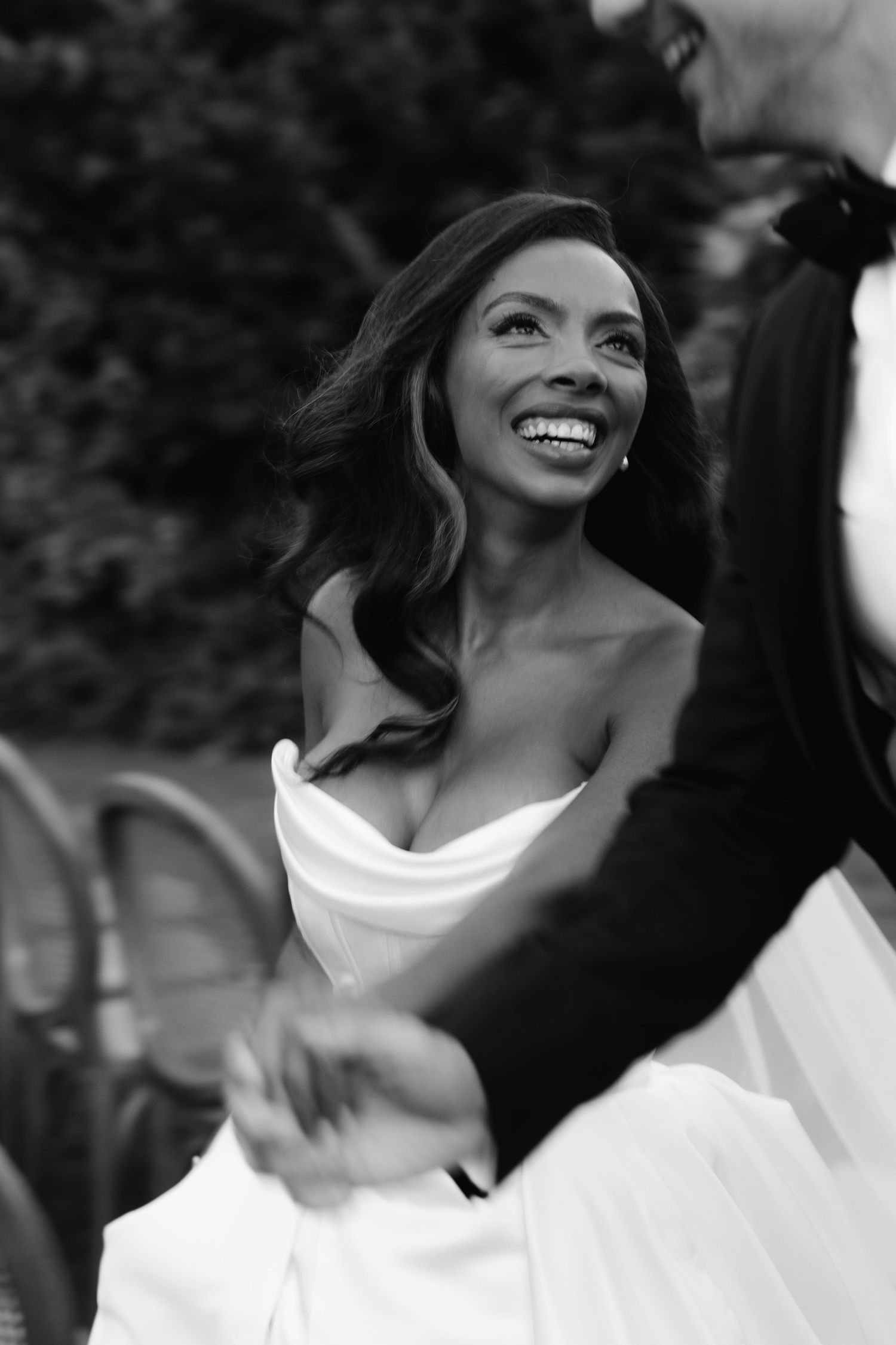 A sequence of black and white portraits showing a person laughing and looking upward with joyful expressions.