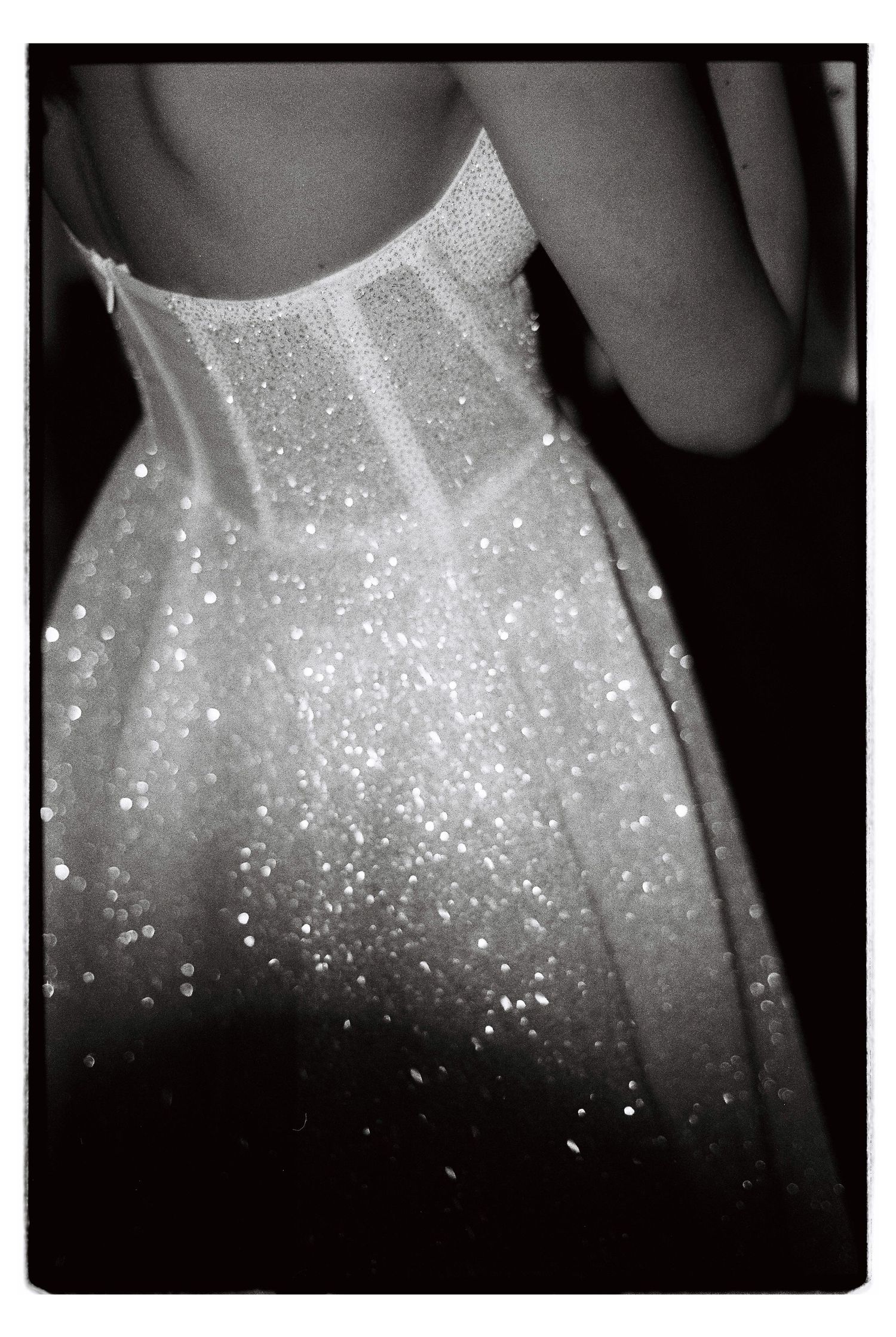 Close-up of a sparkly white wedding dress bodice catching the light.
