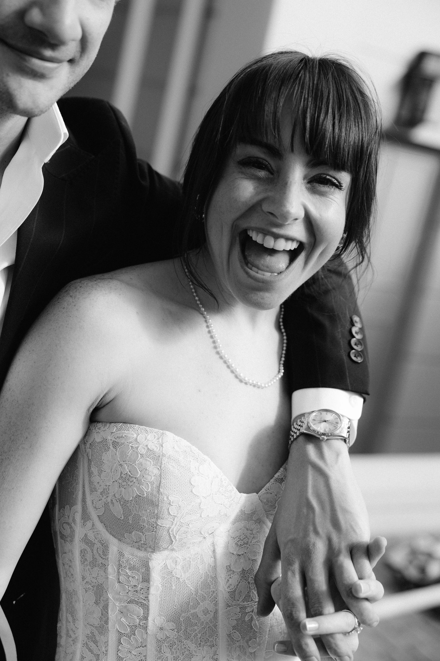 Black and white photo series showing joyful wedding moments with close-up shots of smiles and laughter.