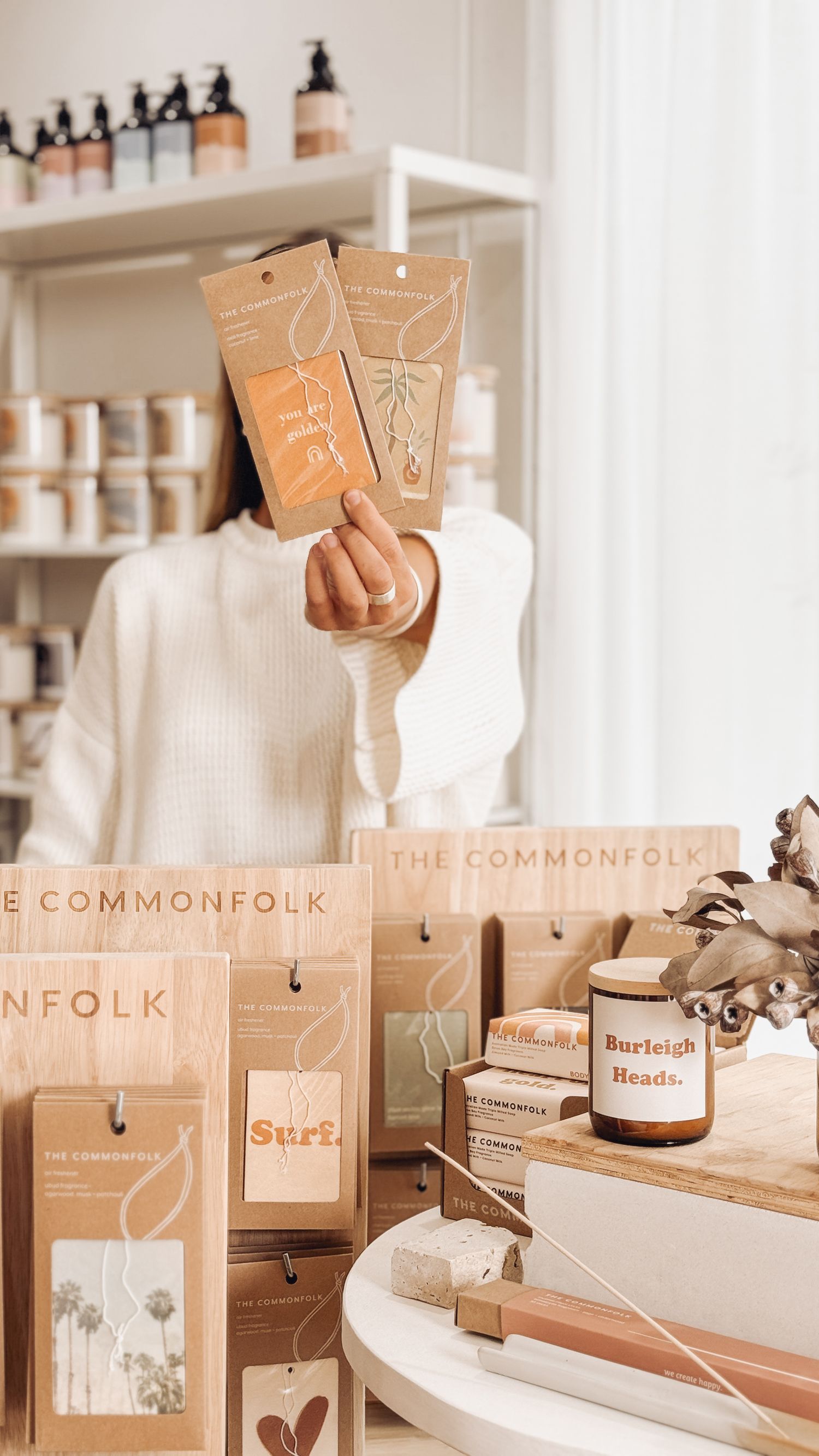 A retail display of The Commonfolk branded products with brown paper packaging and natural aesthetic.