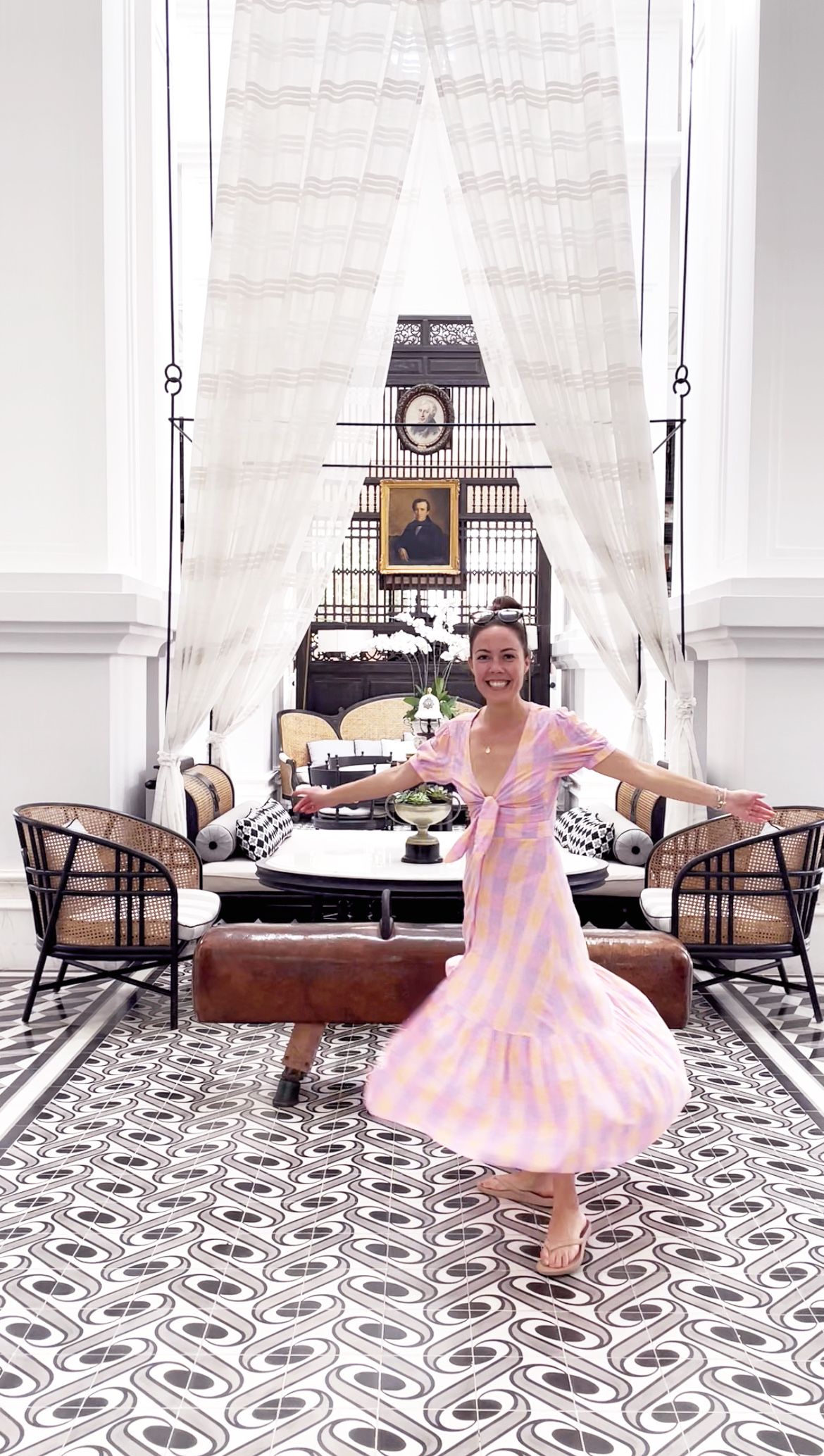 Luxurious room with geometric tiles and white curtains showcasing a pink polka dot dress.