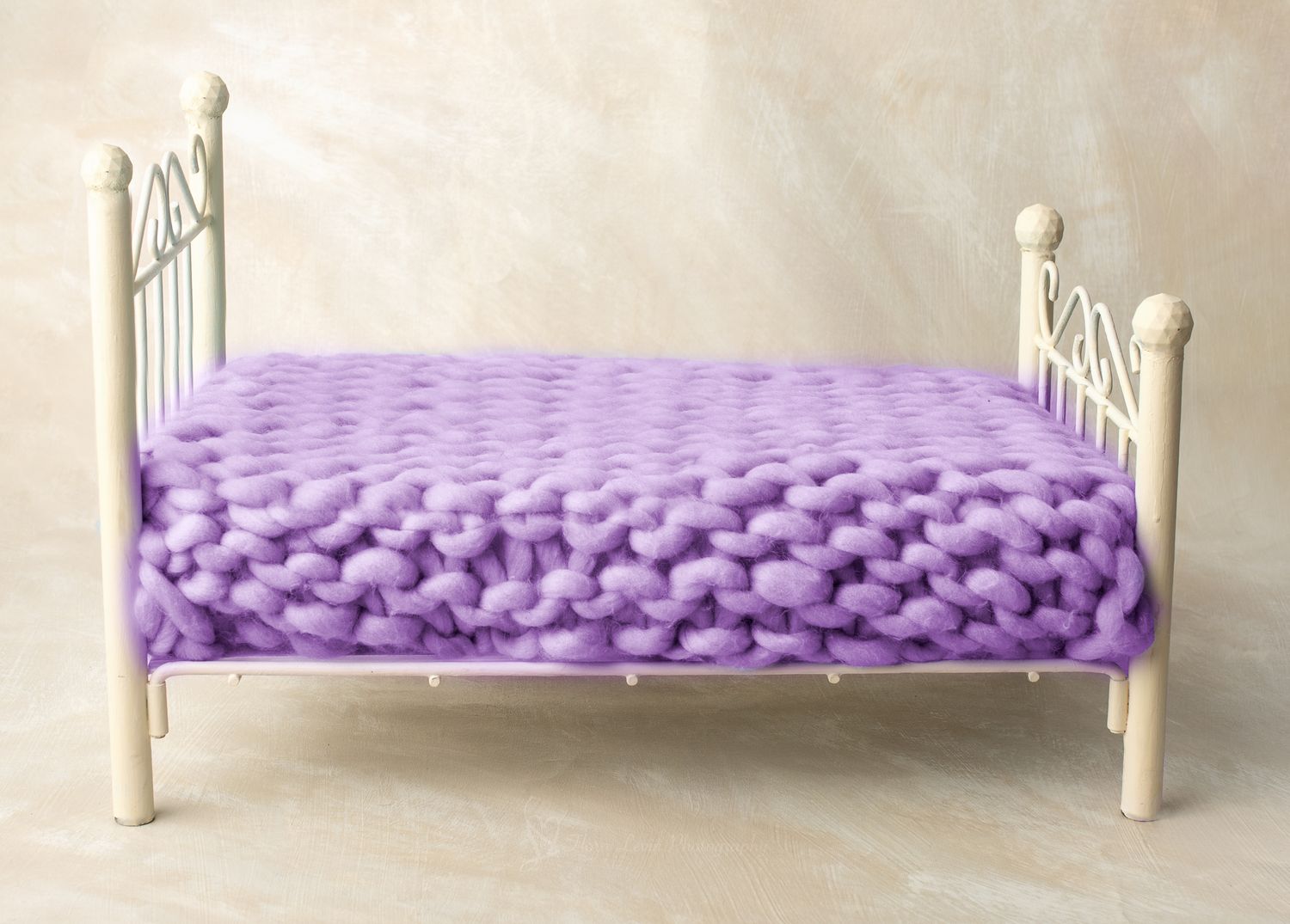 White metal propbed with chunky knit purple blanket, perfect for newborn photography props.