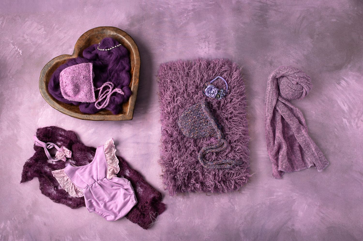 Dark tones Purple newborn photography props including fuzzy blanket, knit bonnet, lace wrap, and heart-shaped wooden bowl.