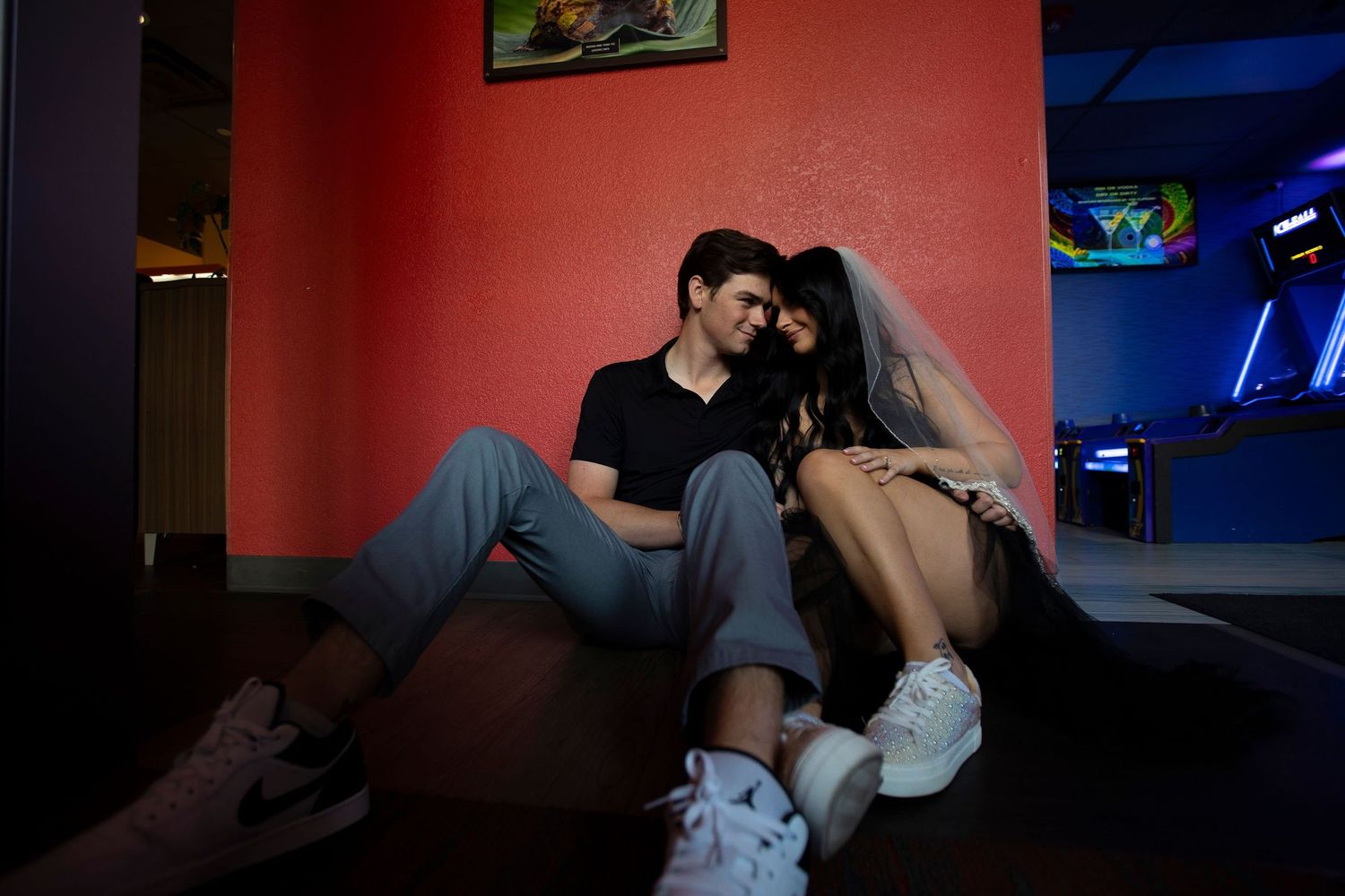 A bride and groom cuddle on the floor of a barricade in Loveland, Colorado after they eloped.