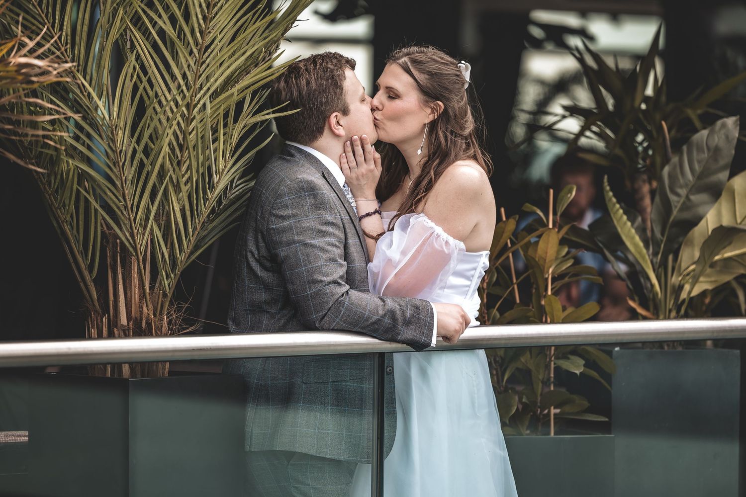 A private couple moment on a balcony taken unobtrusively during a wedding day