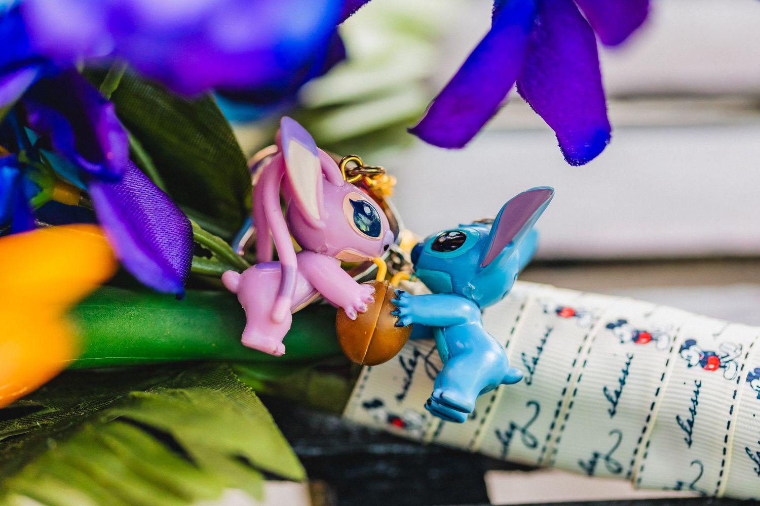 Purple iris flowers and handwritten sheet music create an artistic still life composition against a white background.