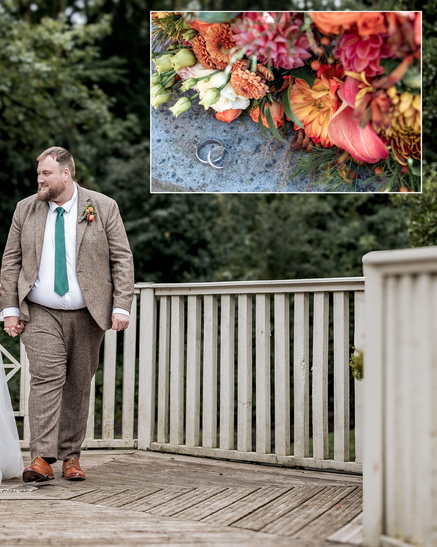 Wedding rings rest on a rustic wooden surface with vibrant coral and pink floral arrangements in the background.