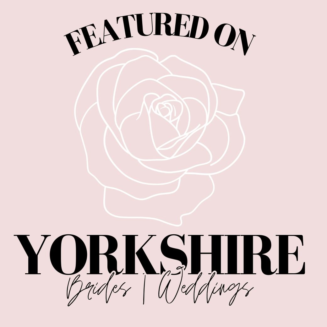 Pink background with decorative rose outline design in white creating an elegant floral pattern.