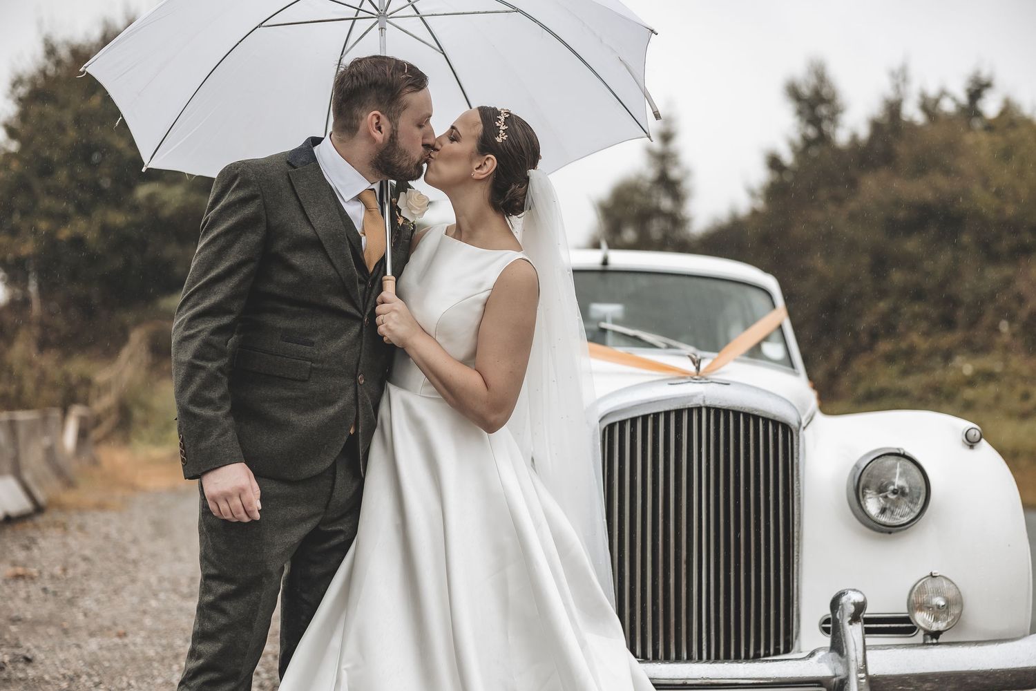 A wedding couple portrait taken on a rainy wedding day