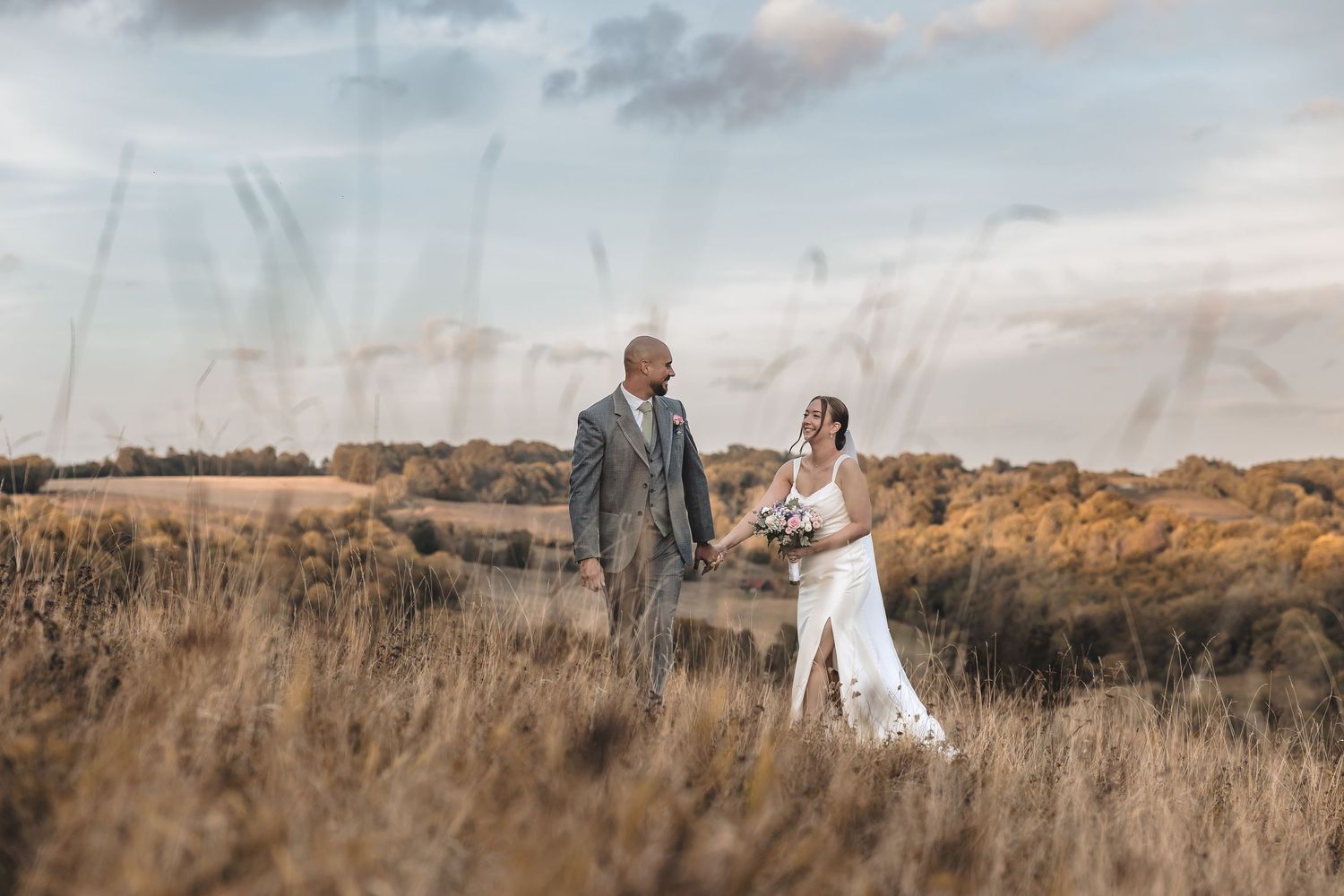 Relaxed wedding couple captured in a open field on their wedding day.