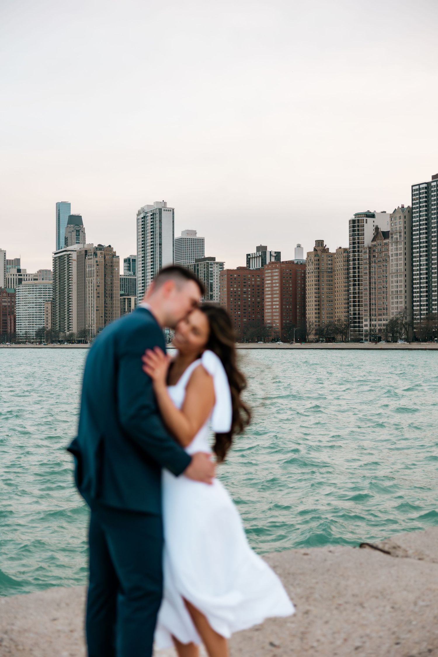 windy city couple on north avenue beach in Chicago, illinois doing an engagement session
