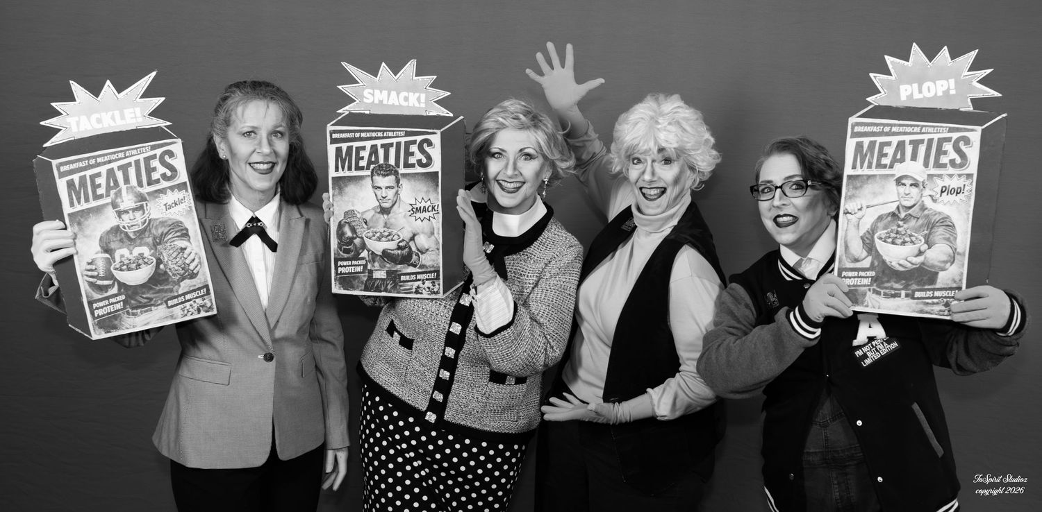 Four women pose holding Meaties cereal boxes in a fun black and white promotional photo.