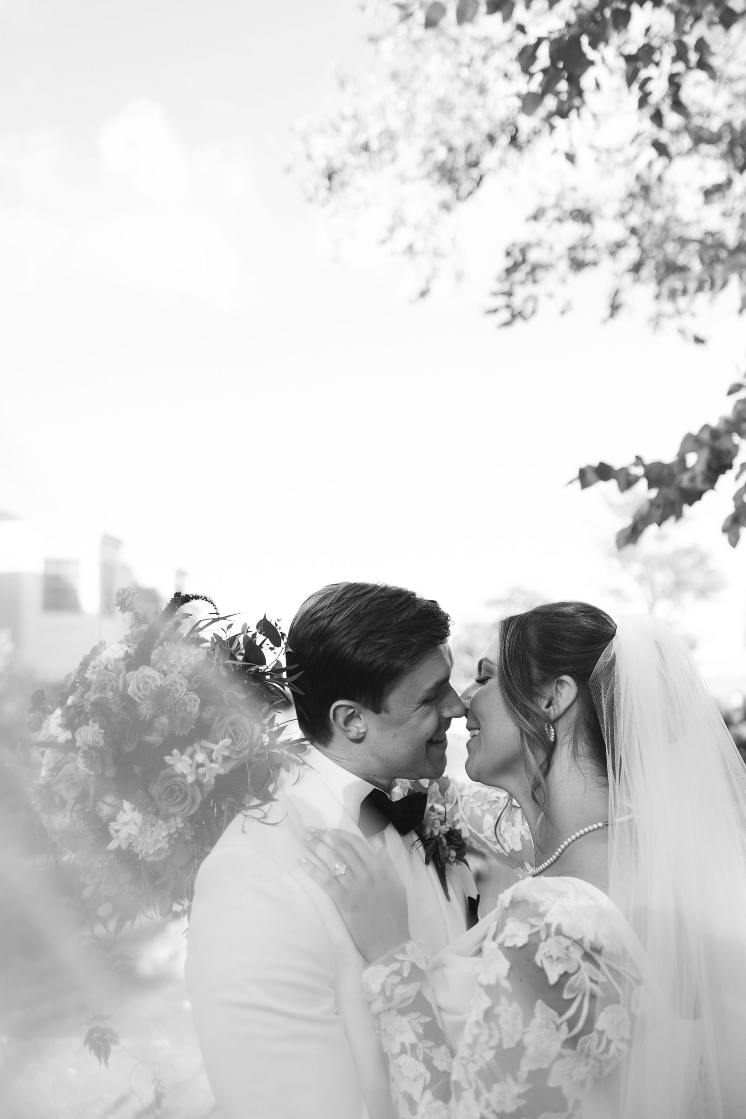 A romantic black and white photo sequence shows a couple in wedding attire sharing intimate kisses through a veil.