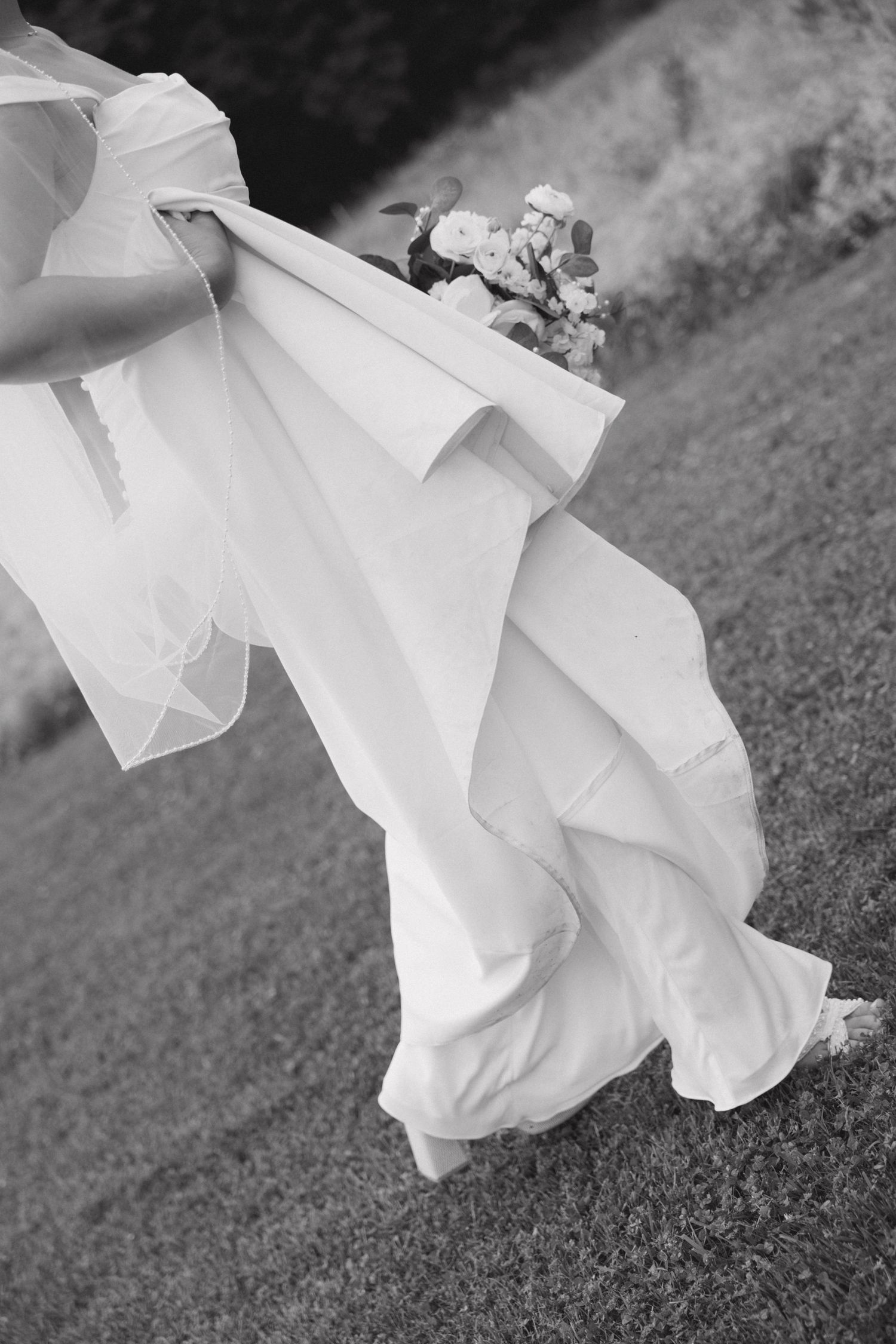 A series of black and white photos showing flowing white fabric against grass in an artistic composition.