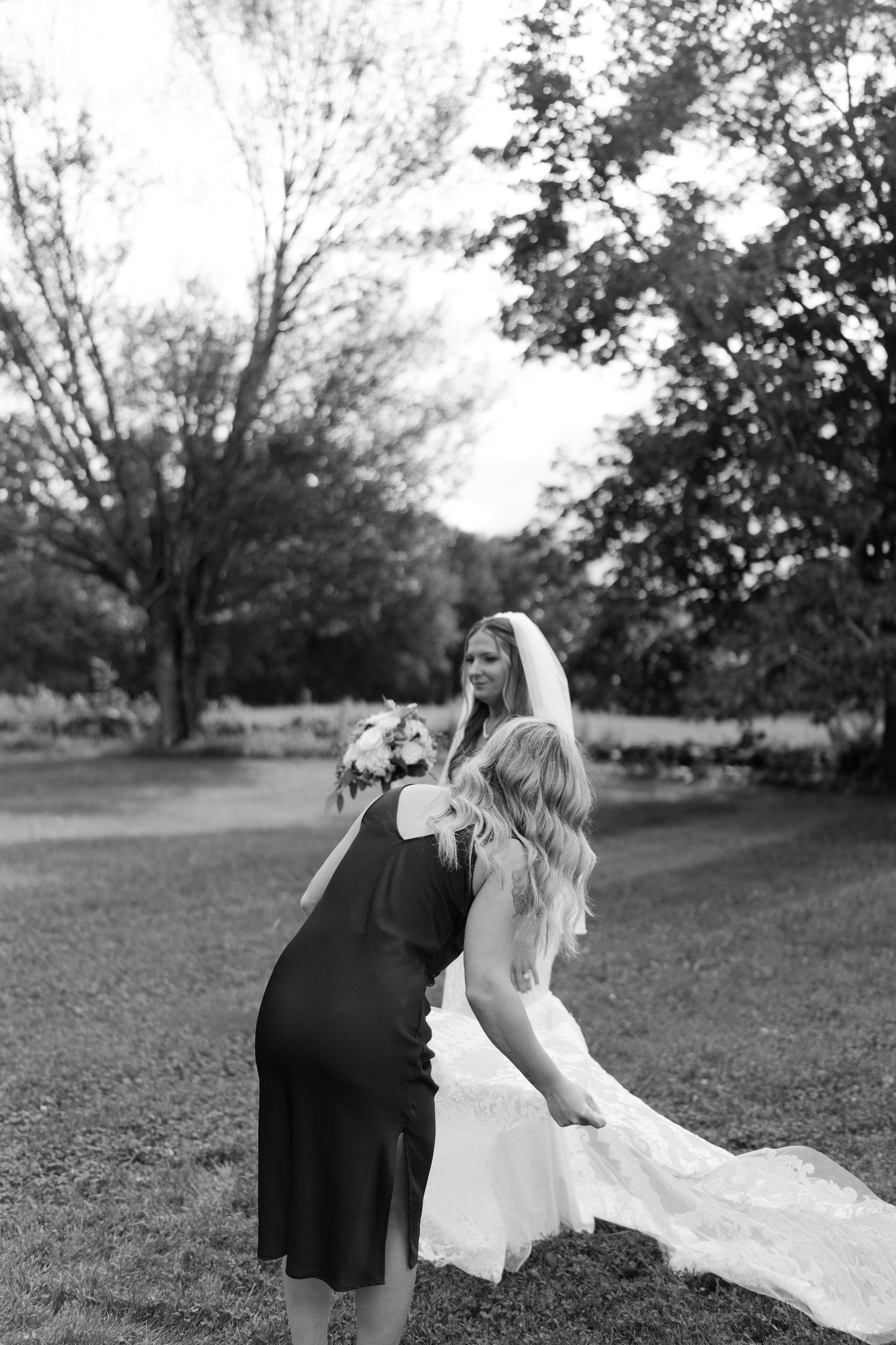 Black and white wedding photography sequence in an outdoor garden setting.