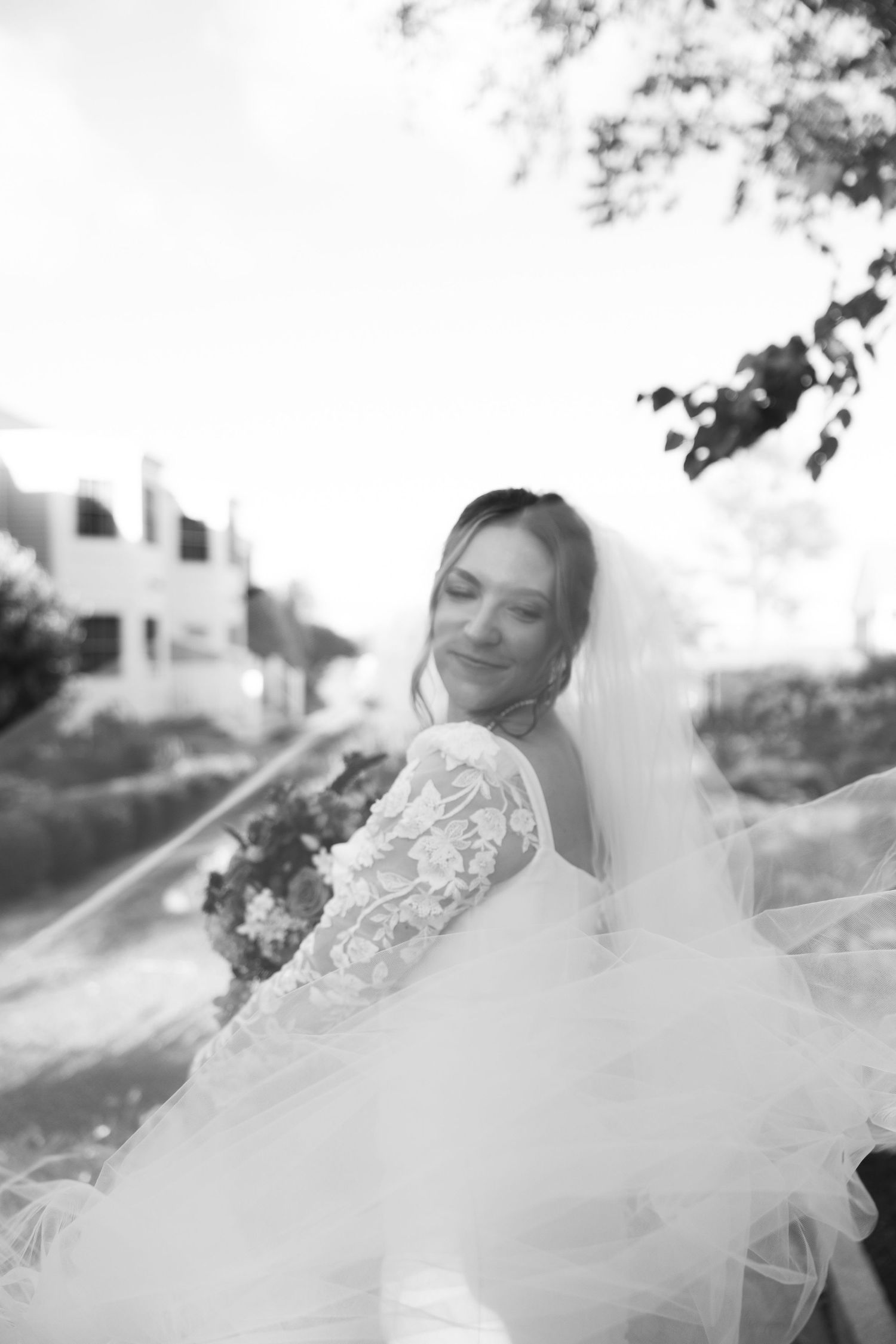 A dreamy black and white photo series showing a person in flowing white fabric against a light background.