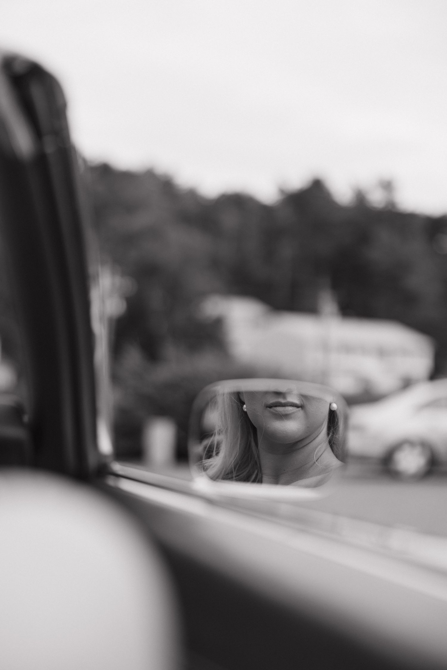 A black and white artistic photo captured through a car window.