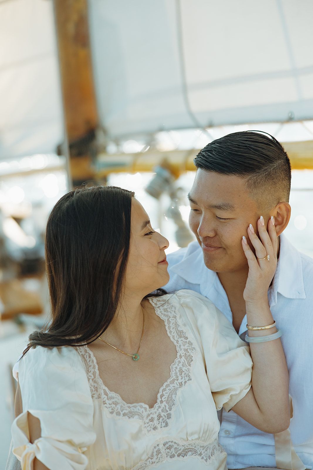 A romantic couple in white outfits share tender moments in a series of intimate photographs.