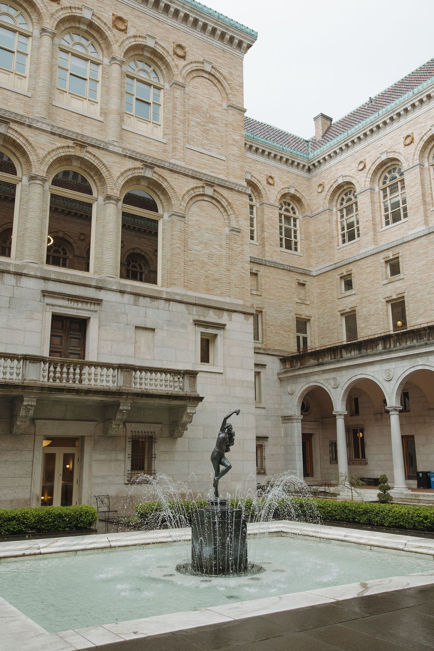 Ornate limestone courtyard with fountain features at the Boston Public Library's historic McKim Building.