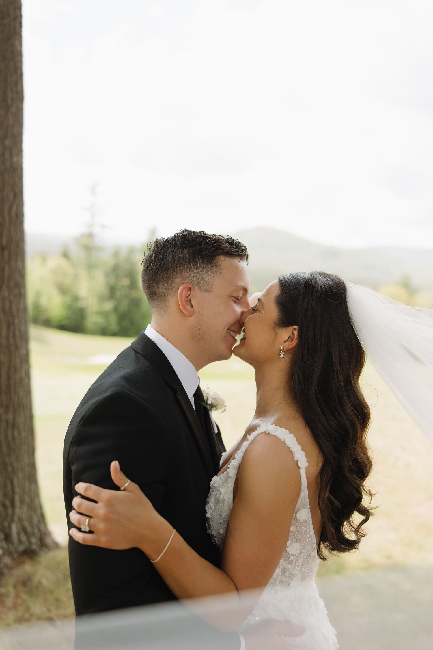 A romantic wedding photo collage showing tender moments between a couple in formal attire against a scenic outdoor backdrop.
