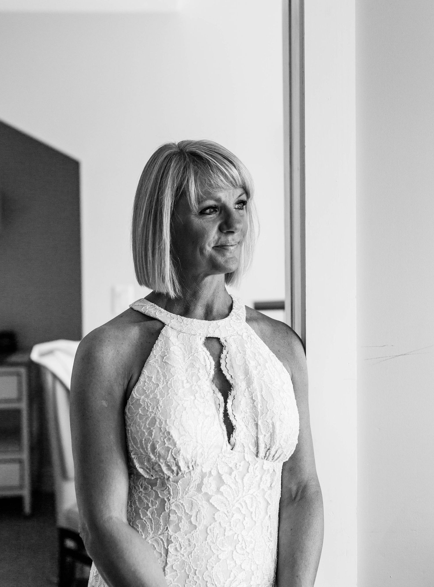 Black and white portraits in a minimalist interior with window lighting.
