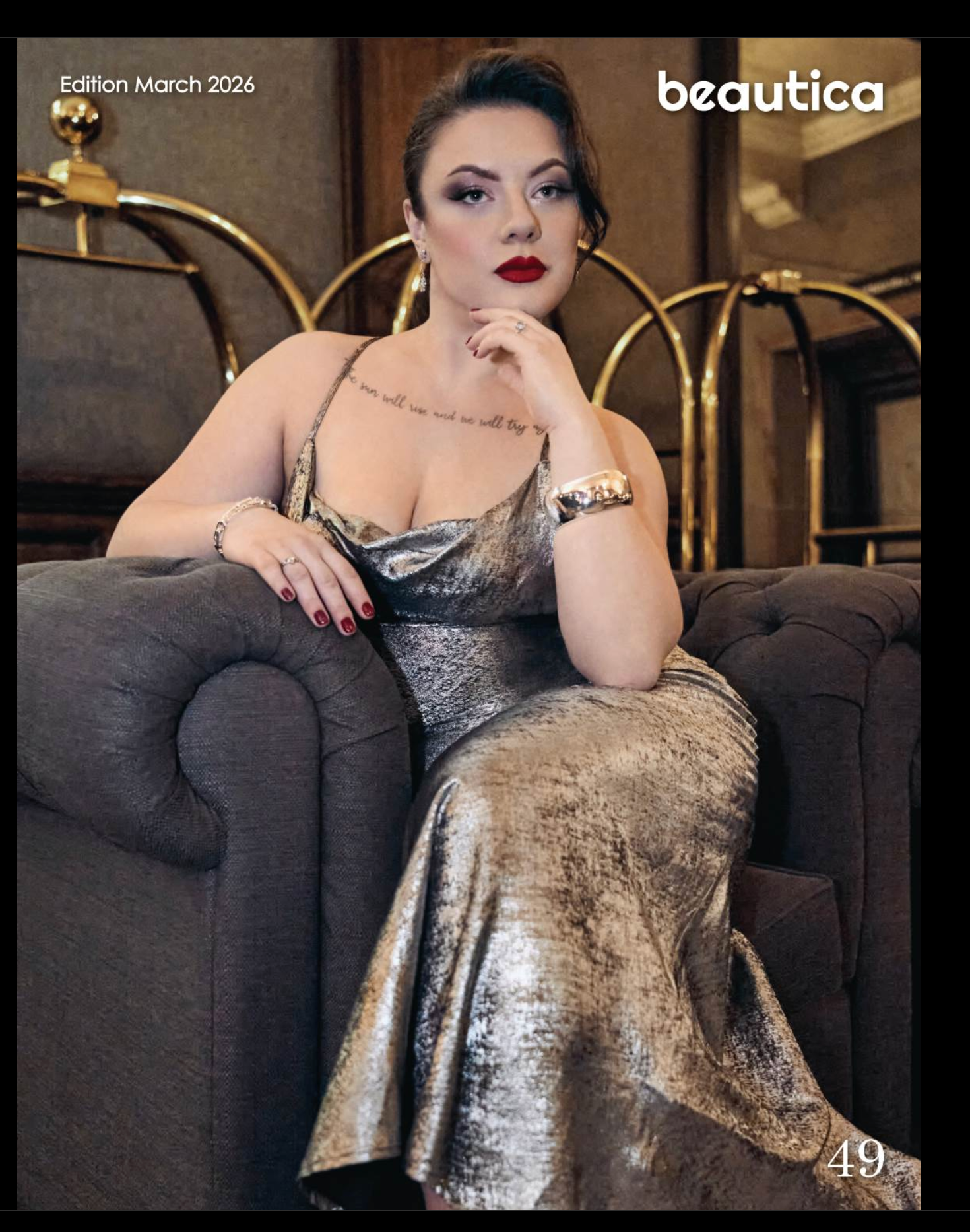 Woman in silver metallic gown poses elegantly on gray chair in Beautica Magazine March 2026 edition, page 49.