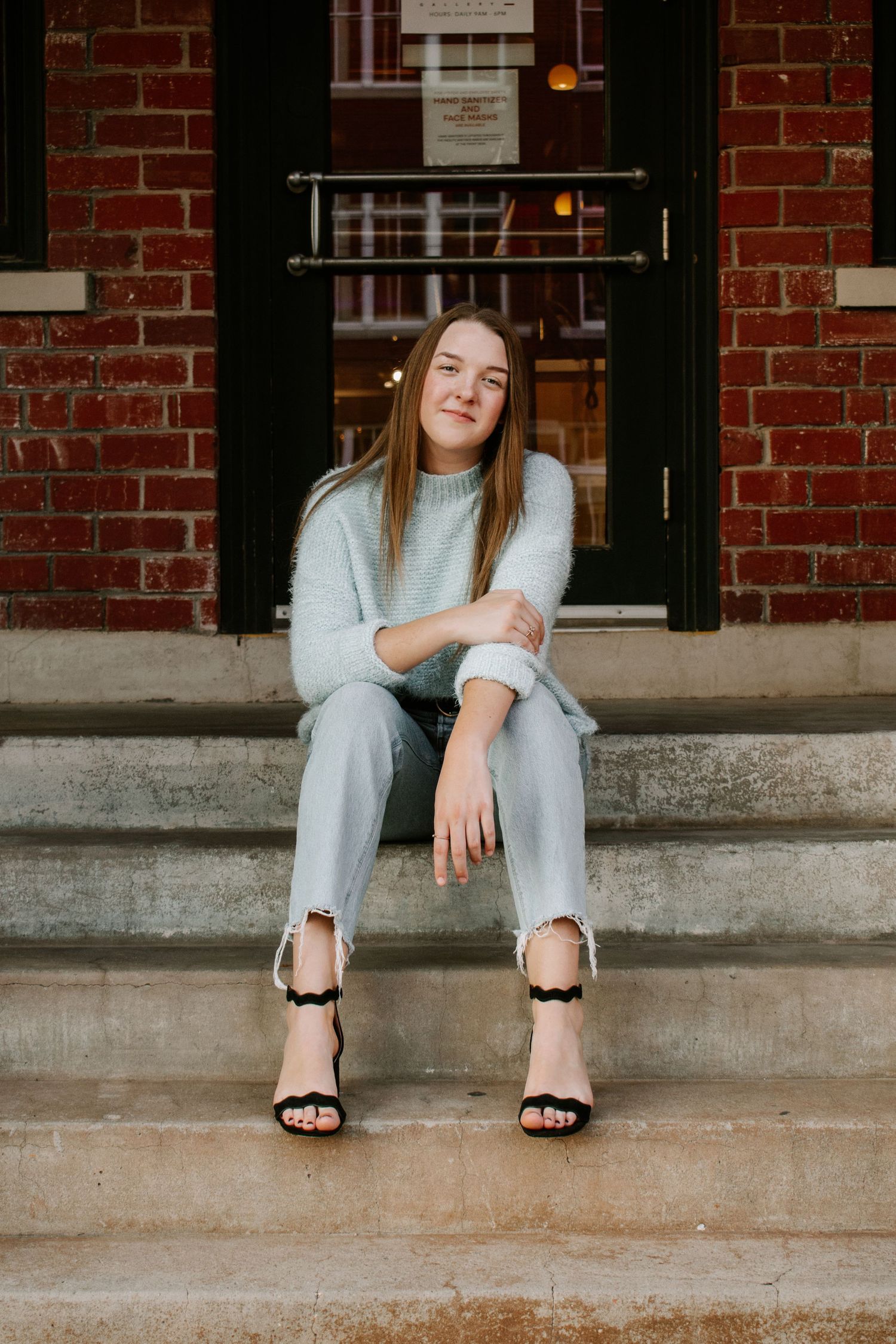 Senior posing on concrete stairs at her downtown Oklahoma City Bricktown senior session