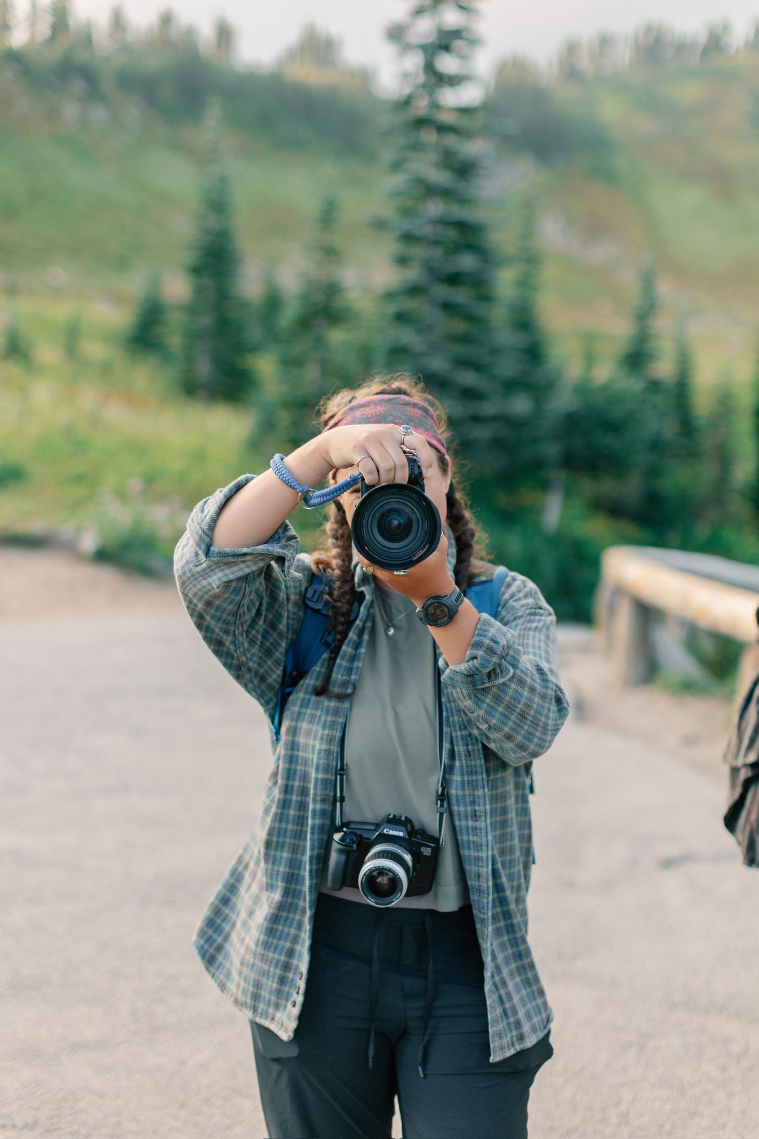 photographer with nikon camera taking picture of viewer in Mount Rainier National Park