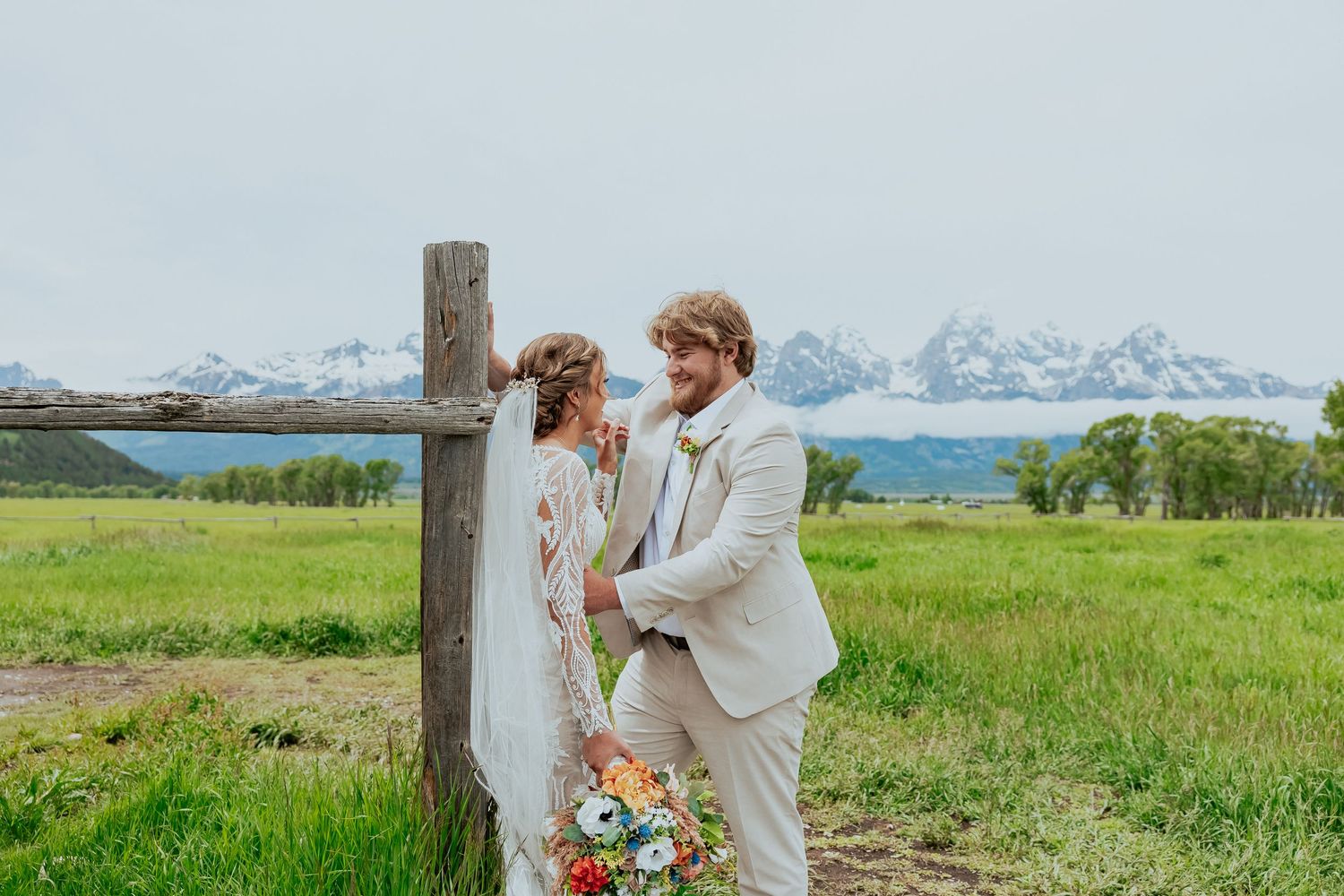A couple shares a tender moment during their mountain wedding photoshoot.