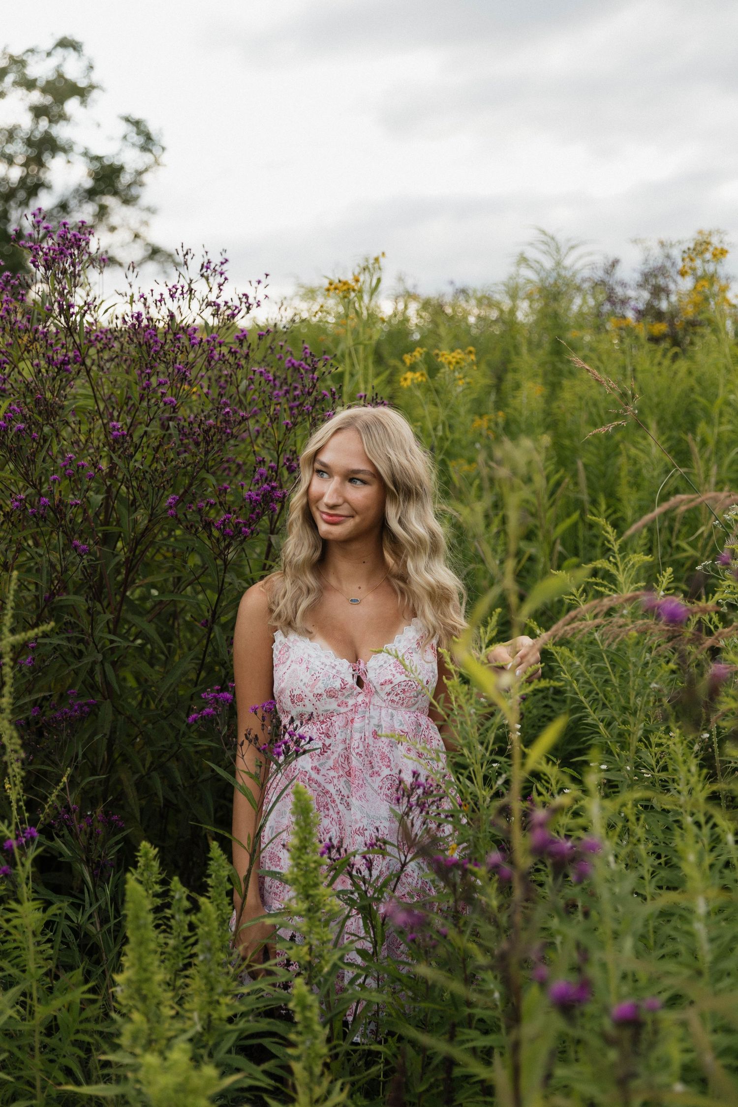 A portrait series in a wildflower meadow with purple and yellow blooms creating a natural outdoor setting.