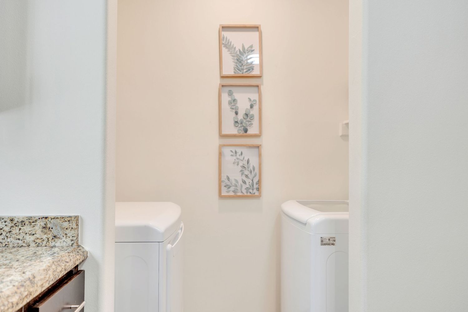 White interior hallway with framed artwork and modern decor elements.