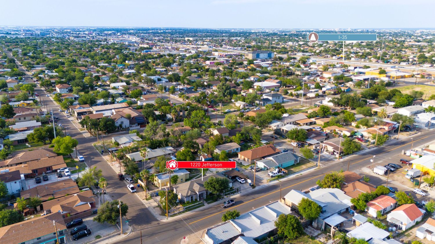 Aerial view of residential neighborhood with houses and streets in Miami suburb under blue sky.