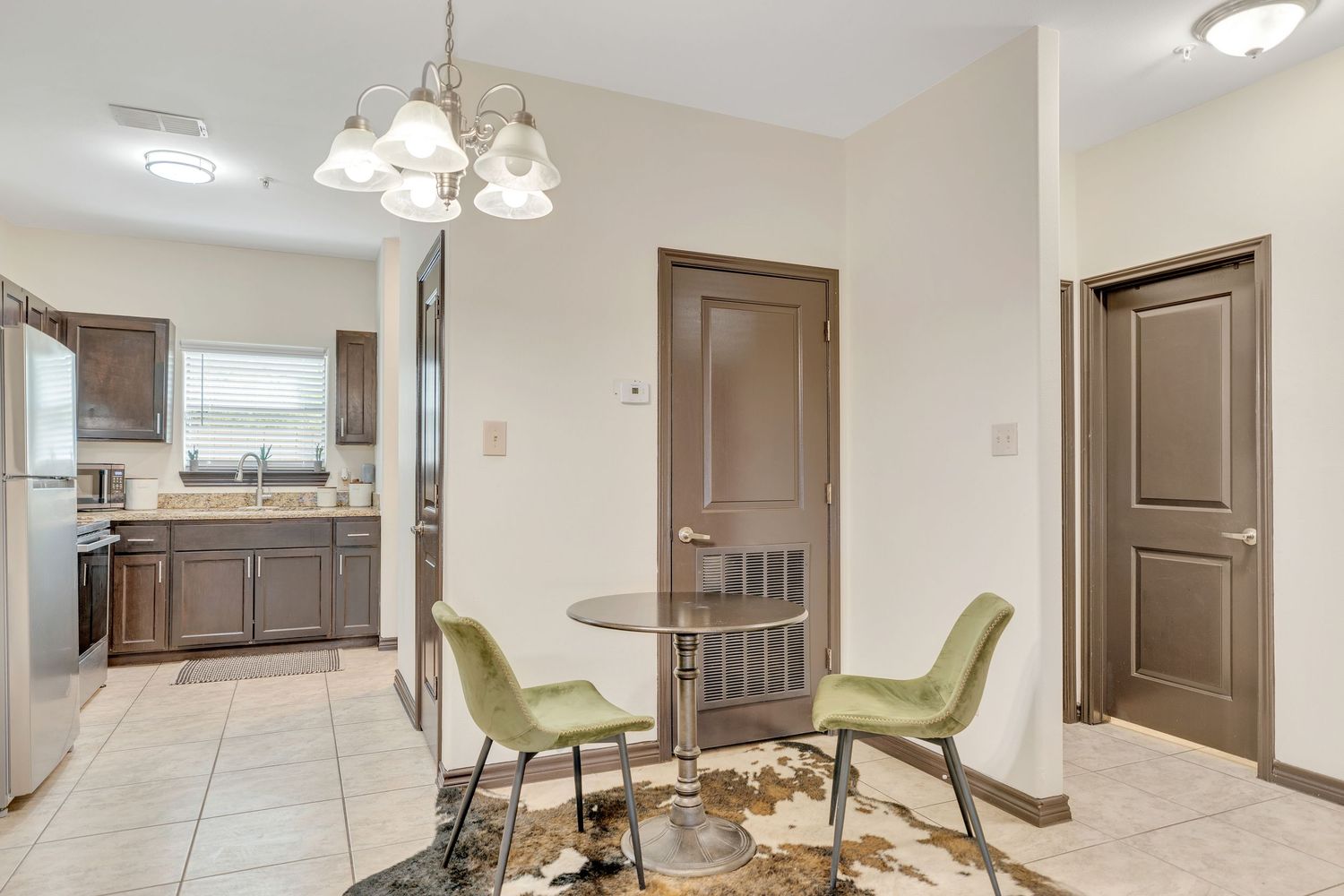 Modern apartment interior showcasing an open floor plan with neutral decor and hardwood floors.